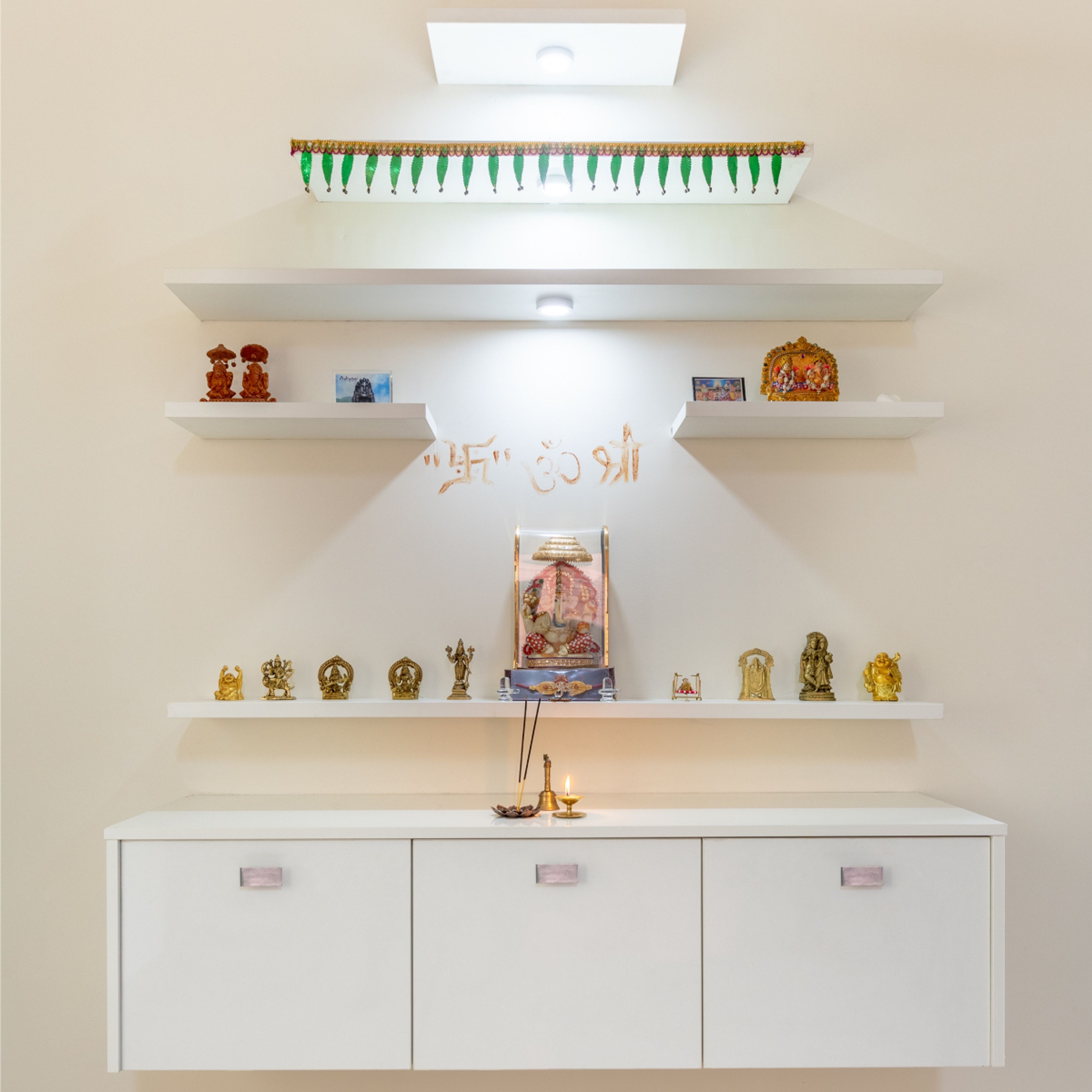 Modern Mandir Design With White Wall Mounted Storage Unit