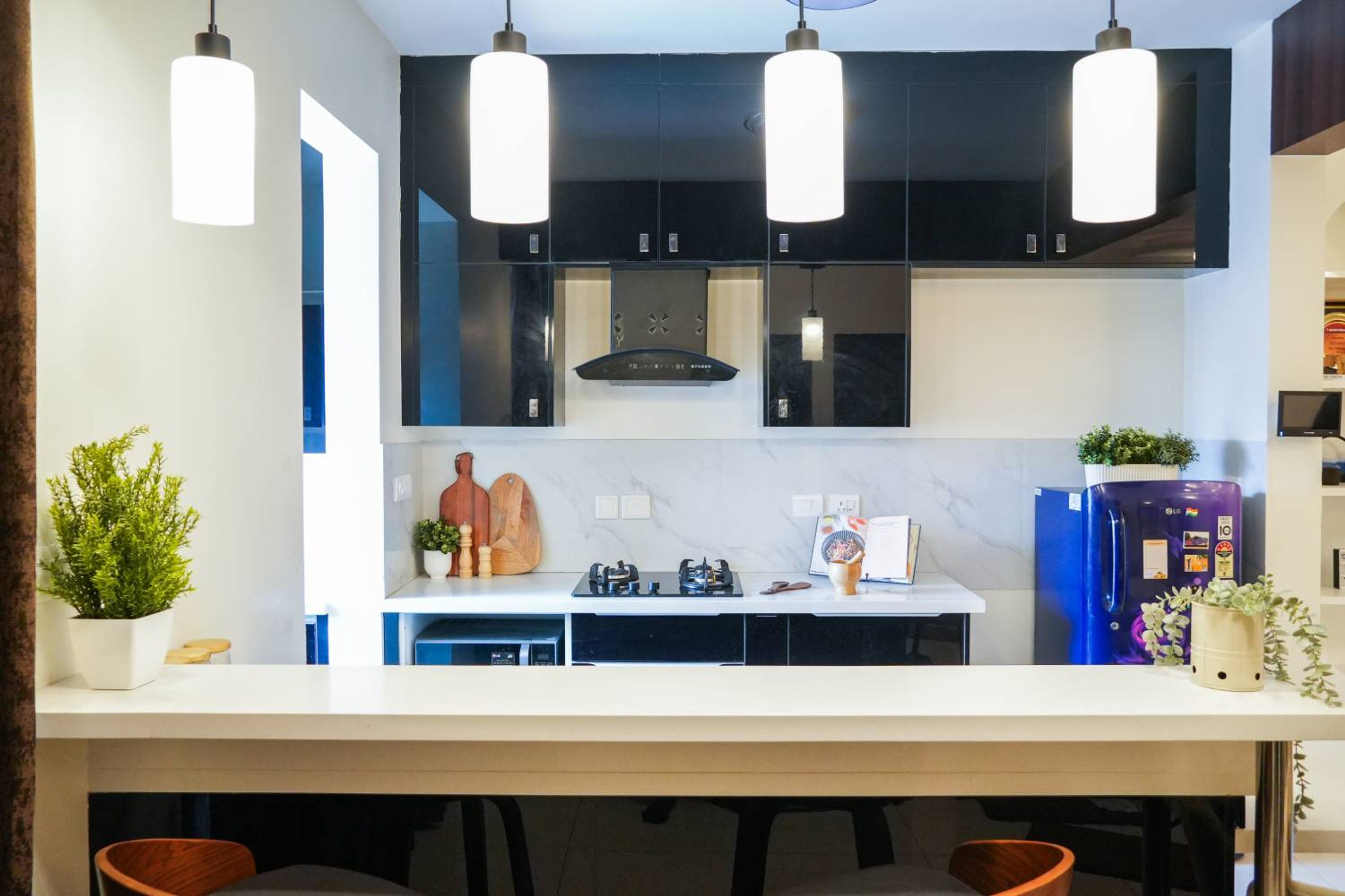 Open Kitchen Design with Balck Wall Cabinets and Pendant Lights
