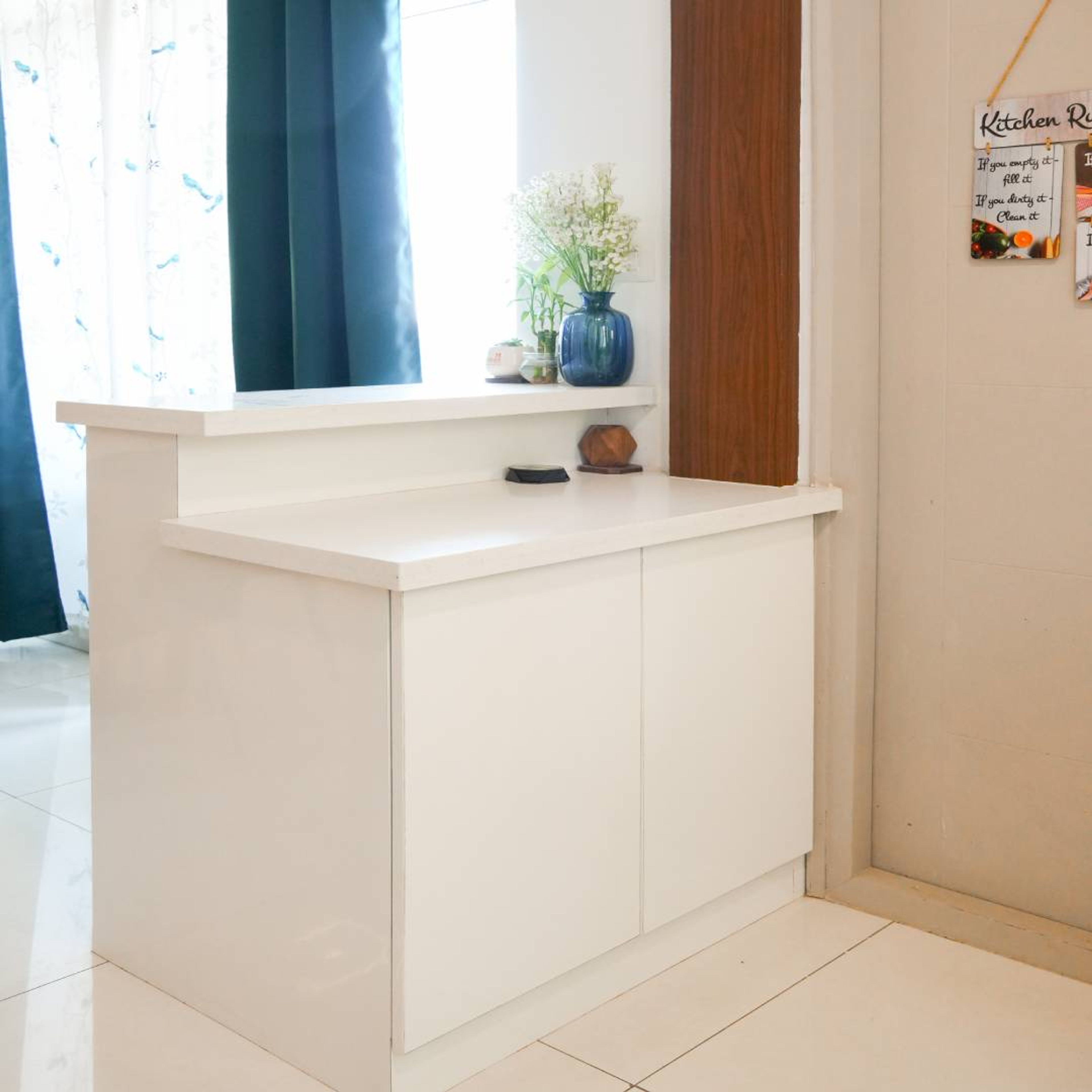 L-Shaped Kitchen Design with White Storage Unit