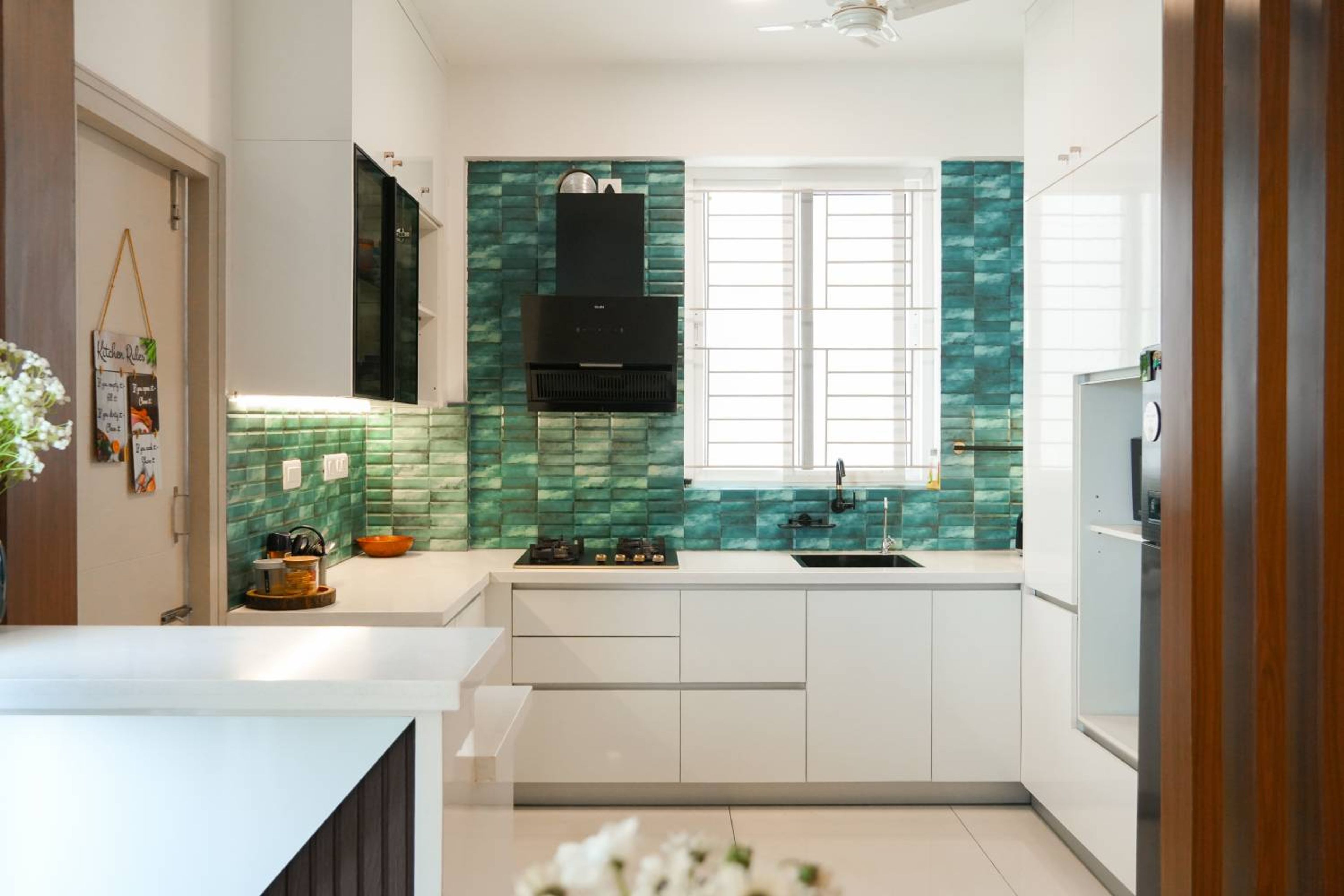 L-Shaped Kitchen Design with Green Tile Backsplash and White Cabinets
