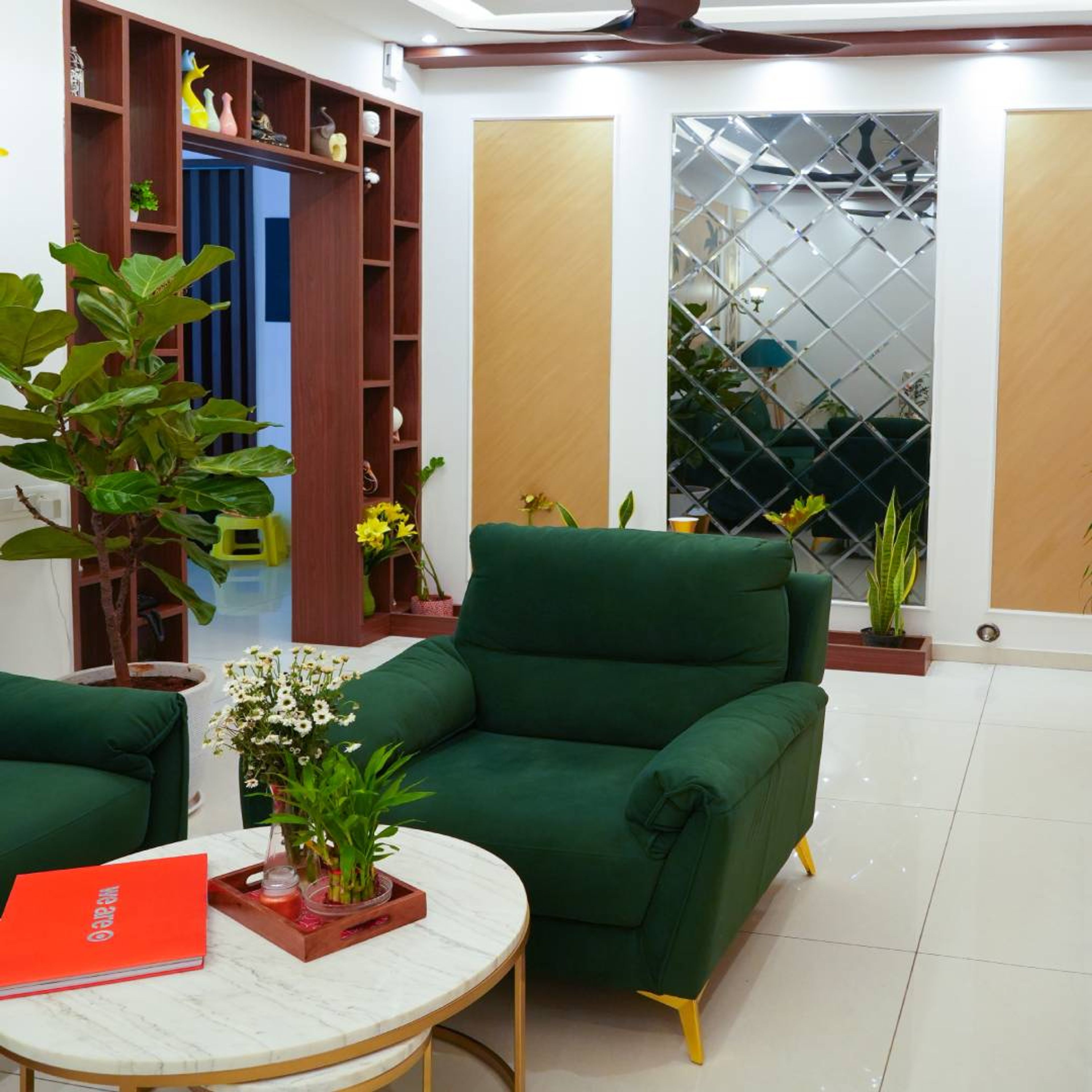 Living Room Design with Dark Green Sofa and Geometric Mirror Wall