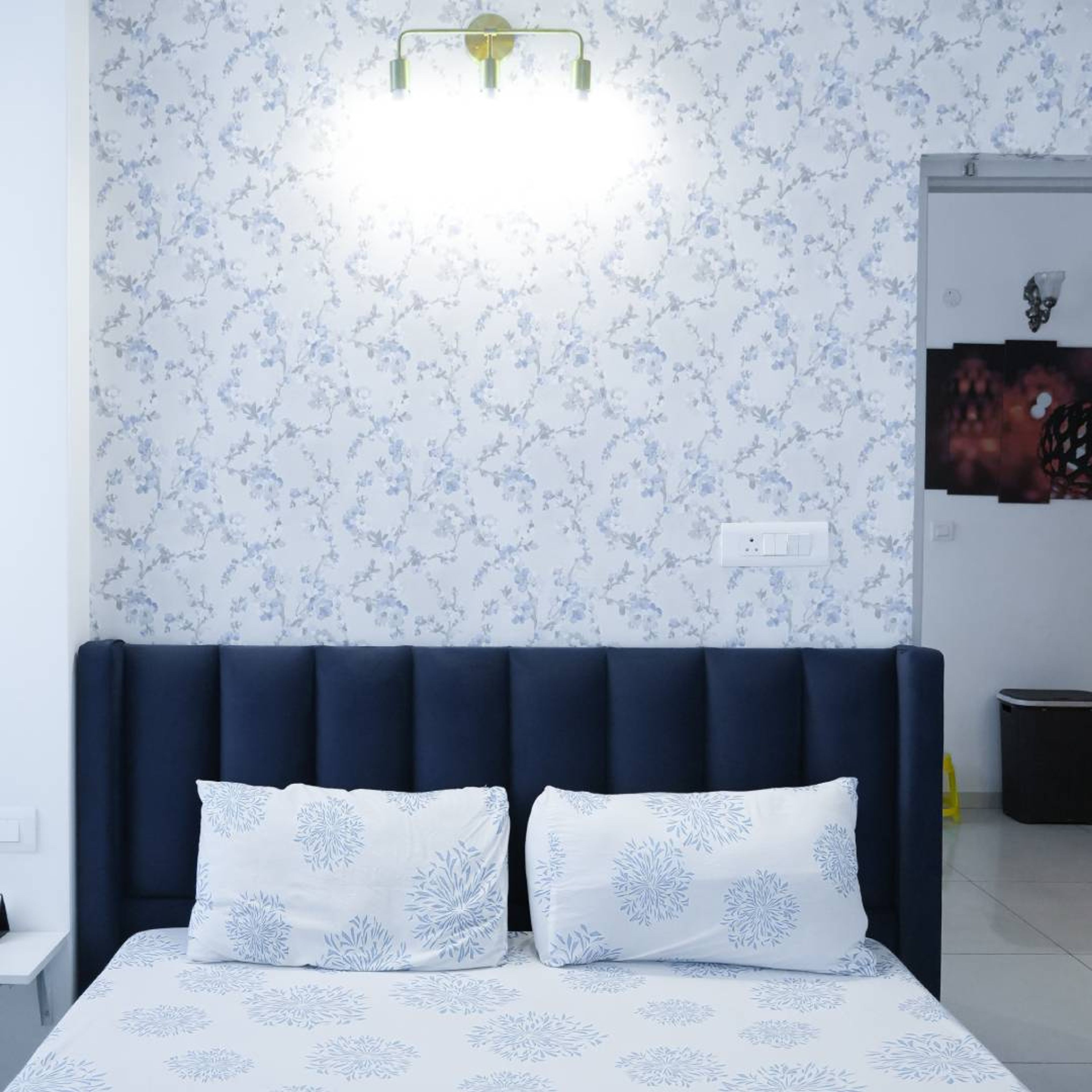 Bedroom Design with White and Blue Floral Wallpaper and Blue Tufted Headboard Bed