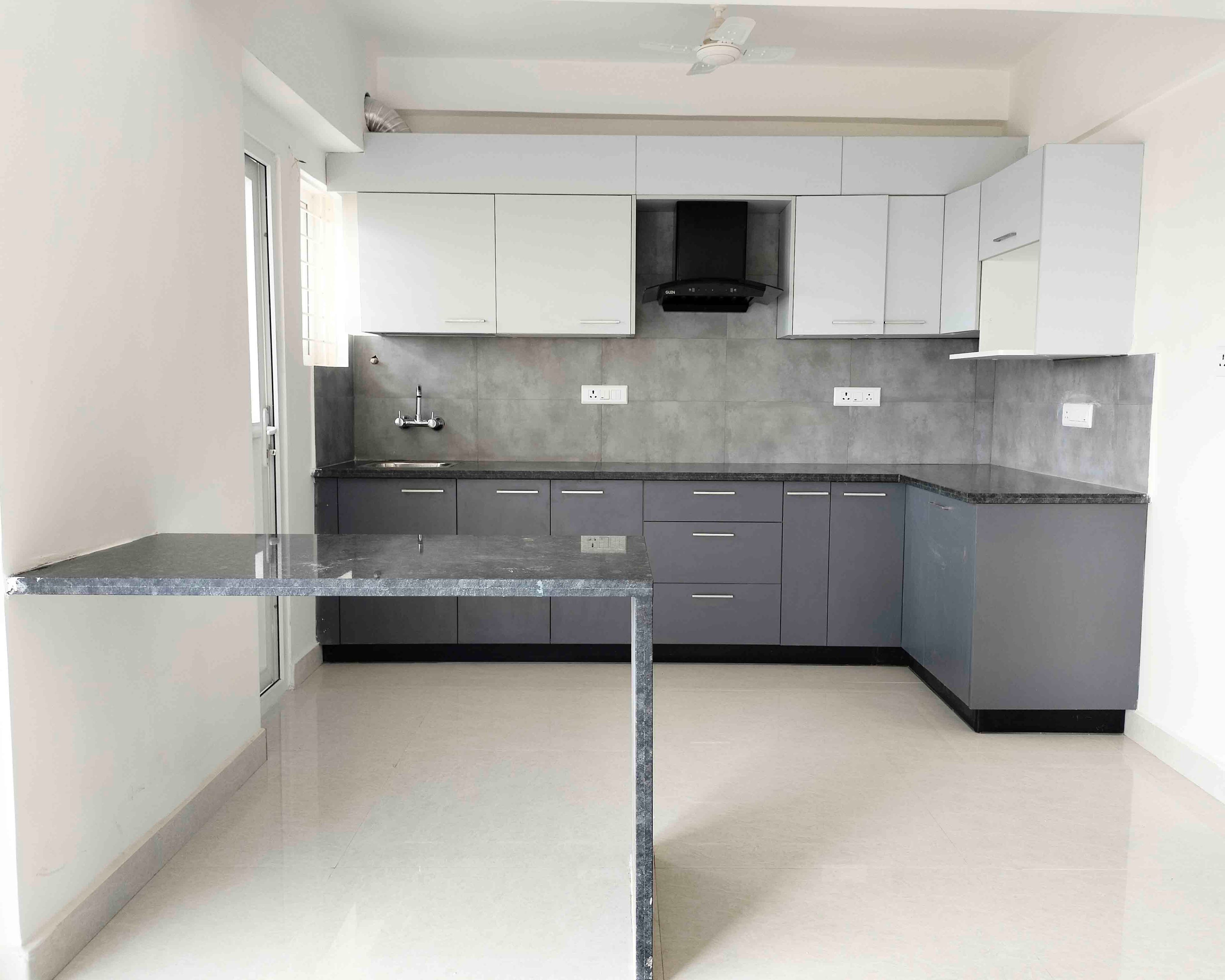 L-Shaped Kitchen Design with Grey and White Units and Wall Mounted Granite Dining Table