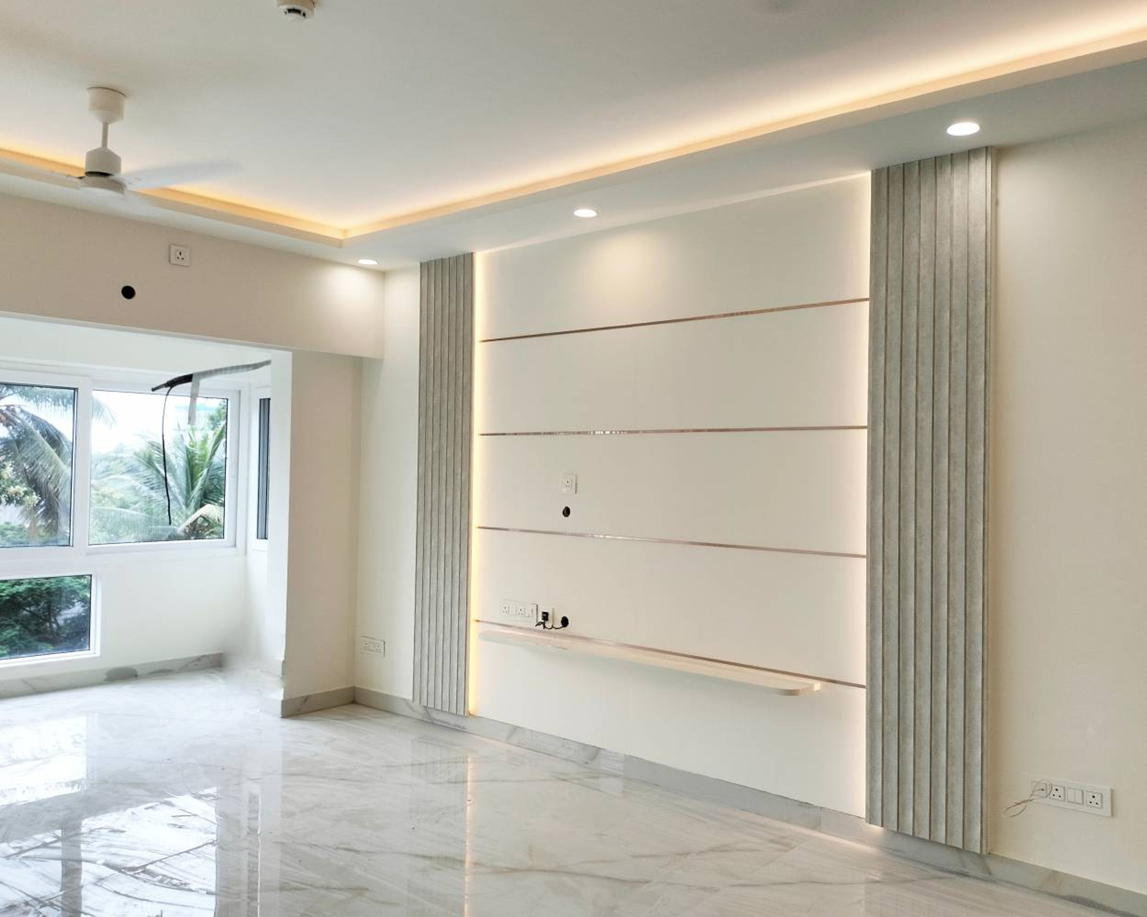 TV Unit Design with Grey Fluted Wall Panels and Off White Wall with Gold Inlays