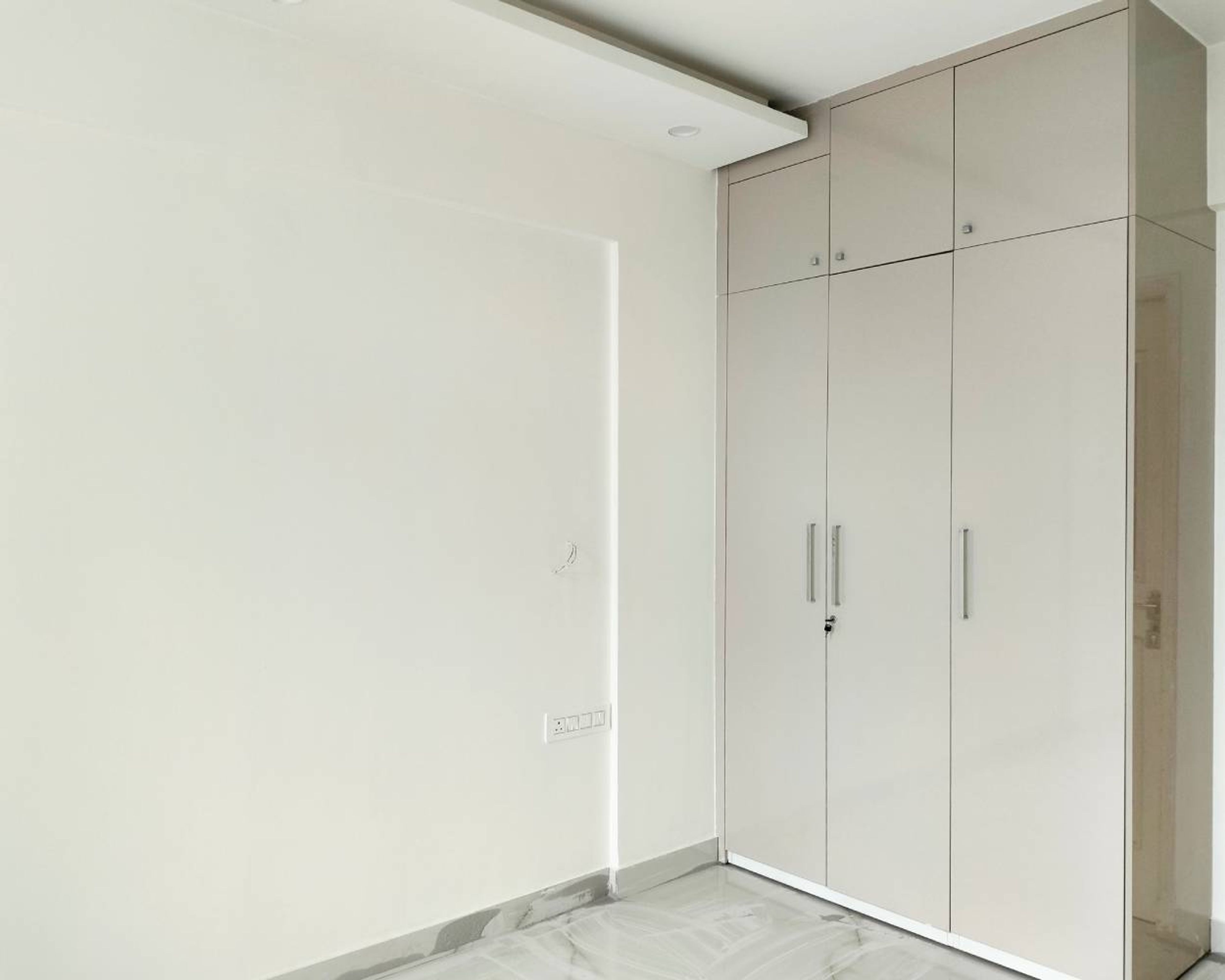 3-Door Beige Swing Wardrobe Design and White Walls