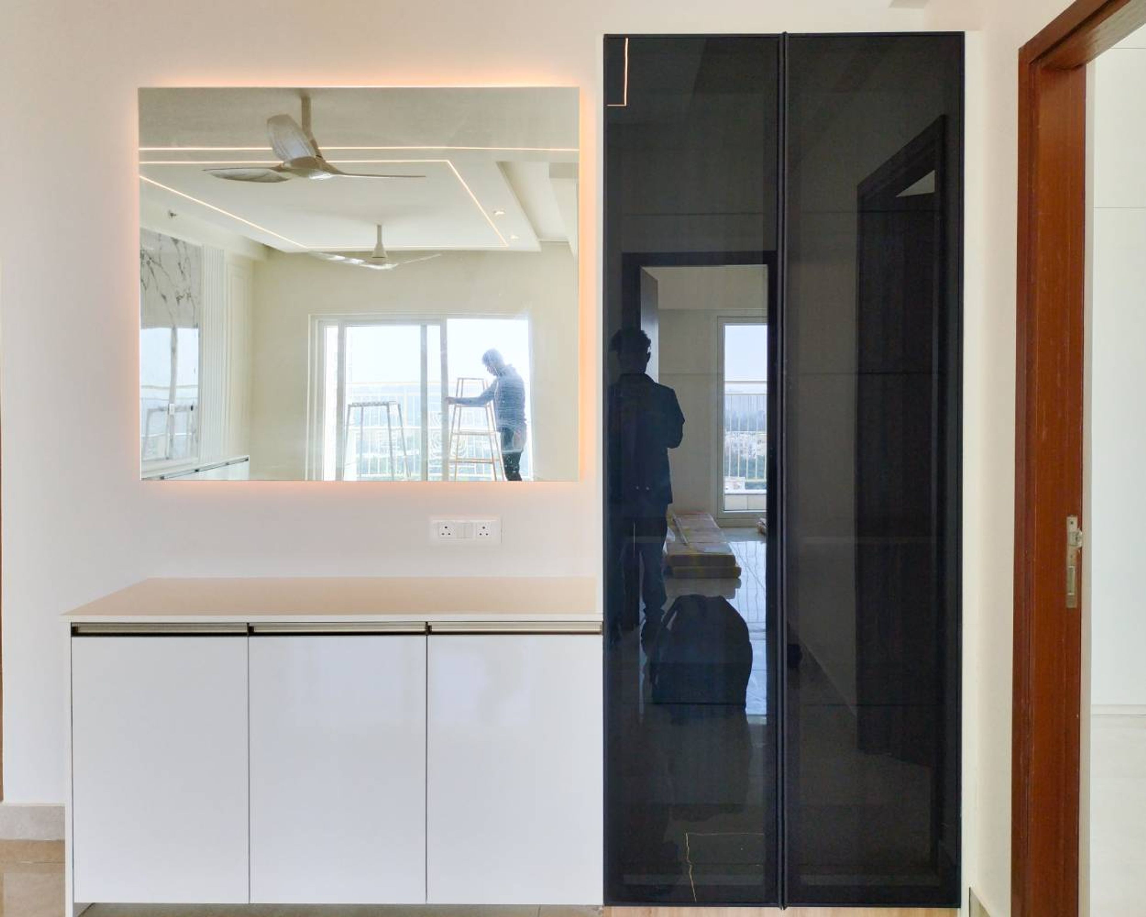 Crockery Unit Design with Black Tinted Glass Tall Unit and Wall Mounted Mirror