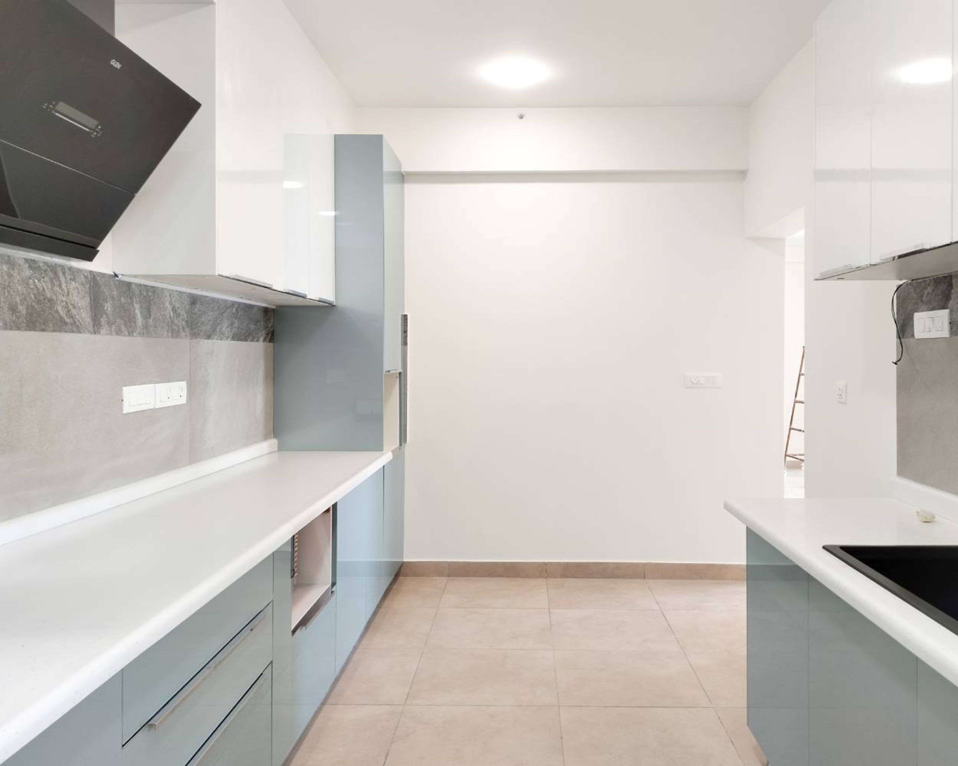 Parallel Kitchen Deign with Blue Base Units and White Wall Units