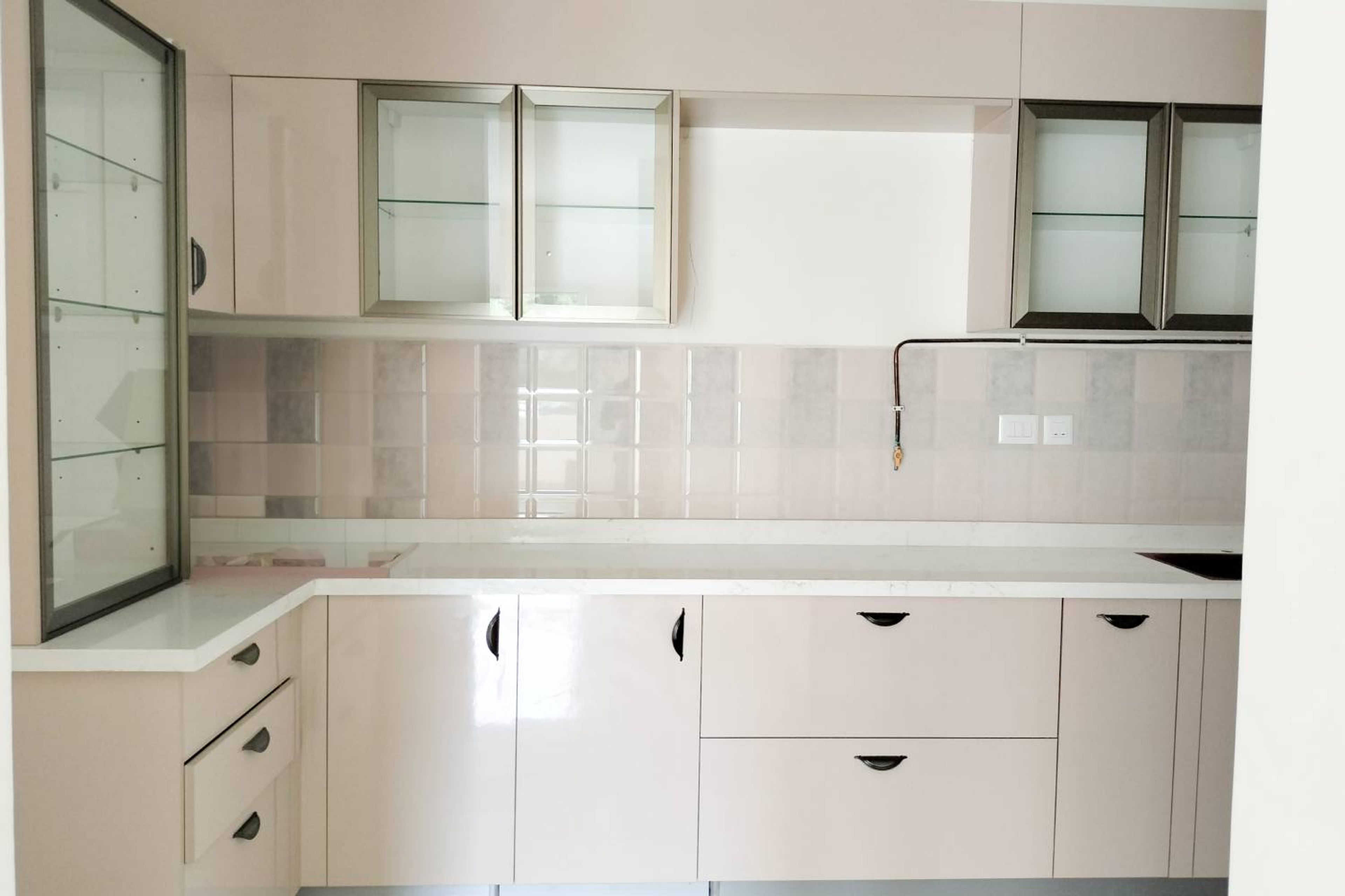 L-Shaped Kitchen with Cream Cabinets with Glass Shutters