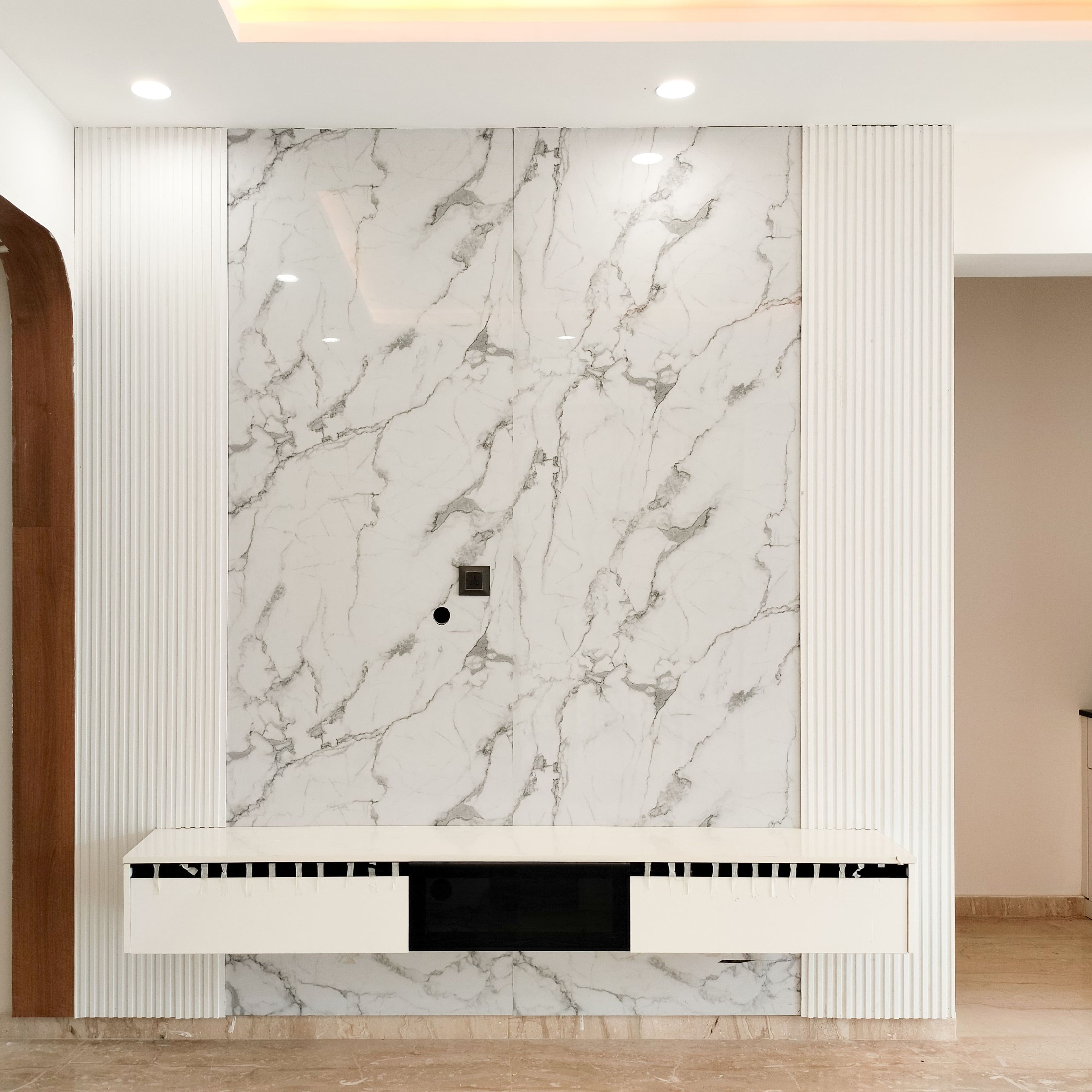 TV Unit Design with White Drawers and Marble Textured Backsplash with White Wall Slats