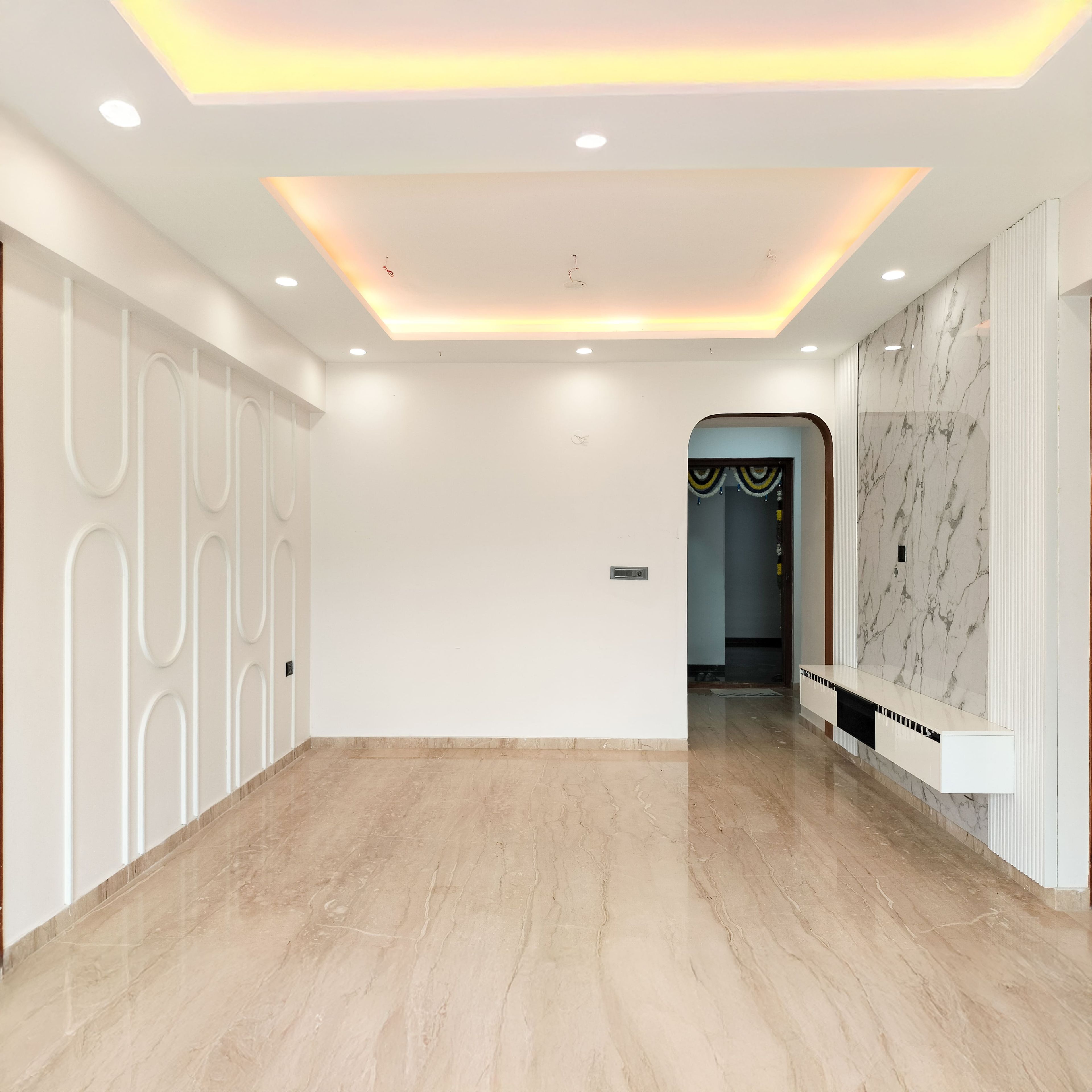 Living Room design with White wall with Arch Shaped Trims and False Ceiling Design