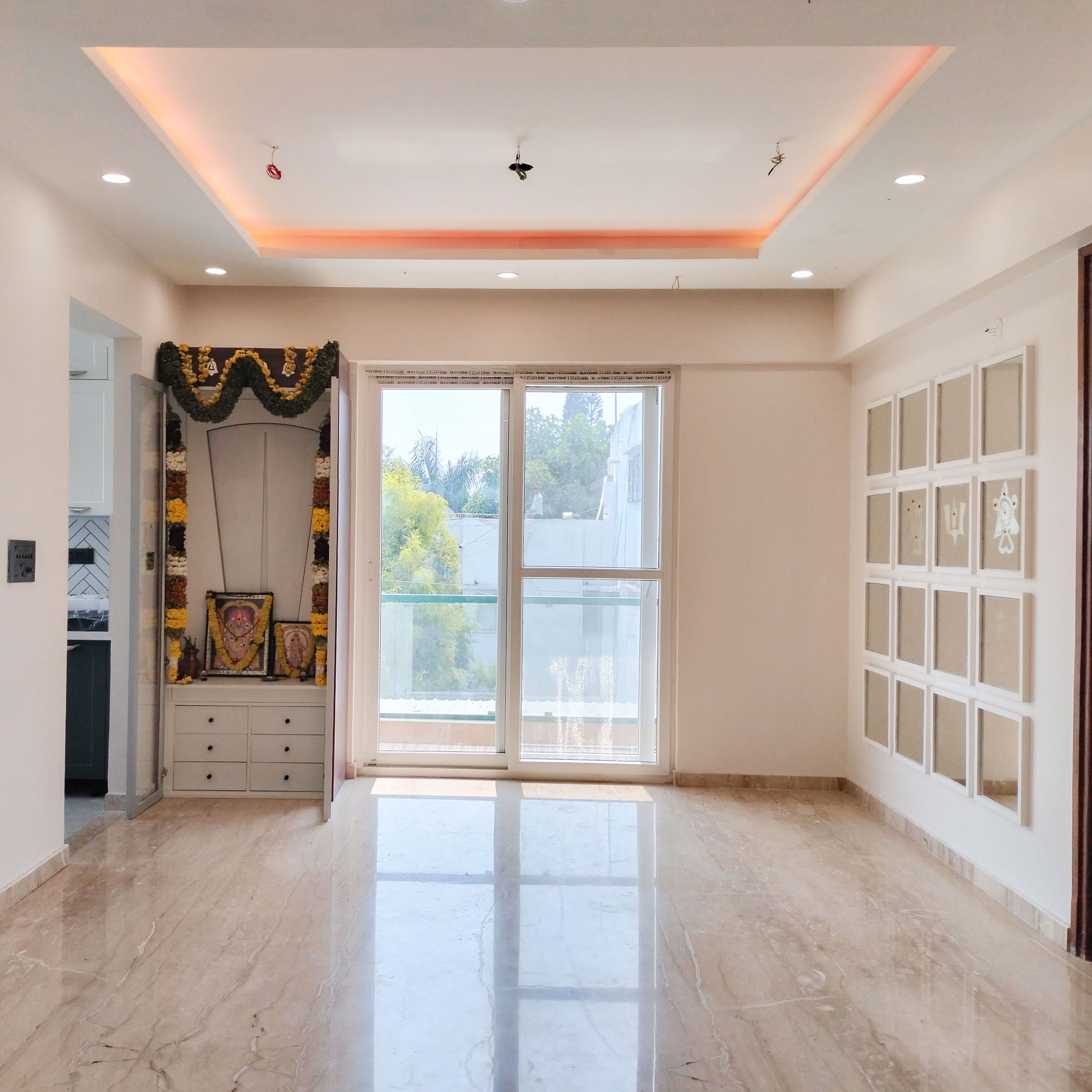 Pooja Unit Design with White Drawers and Mirrored Wall Design