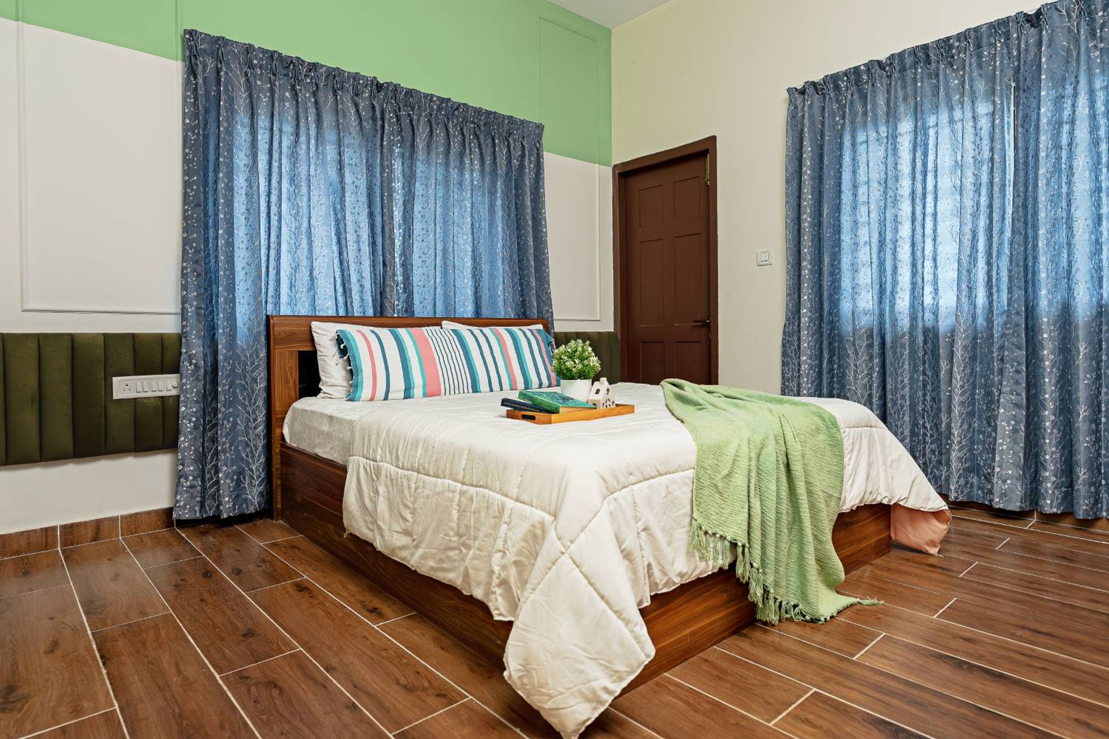 Bedroom Design with Half Cushioned Green Headboard Wall and Wooden Flooring