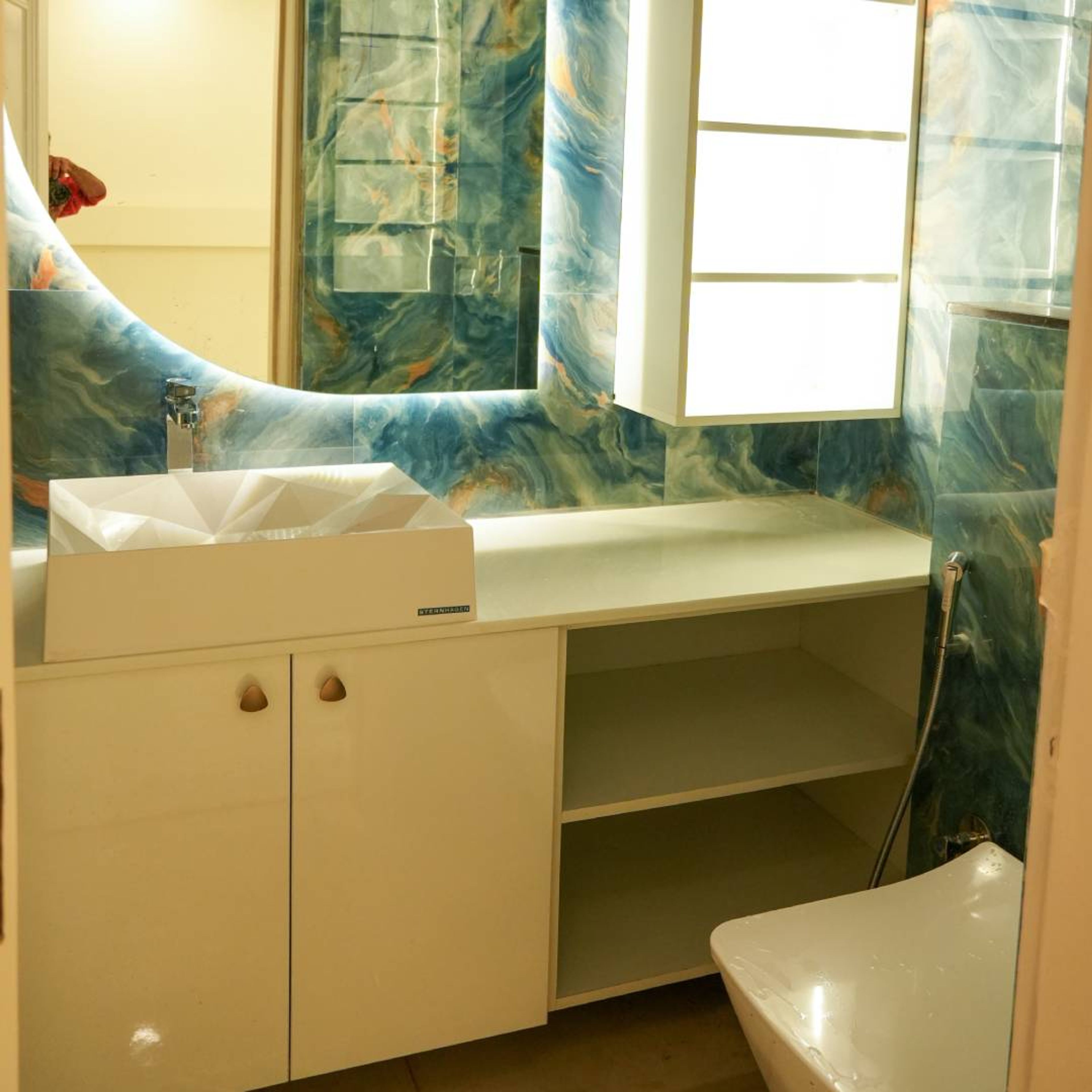 Blue Bathroom Design with Marbled Walls and Mirror