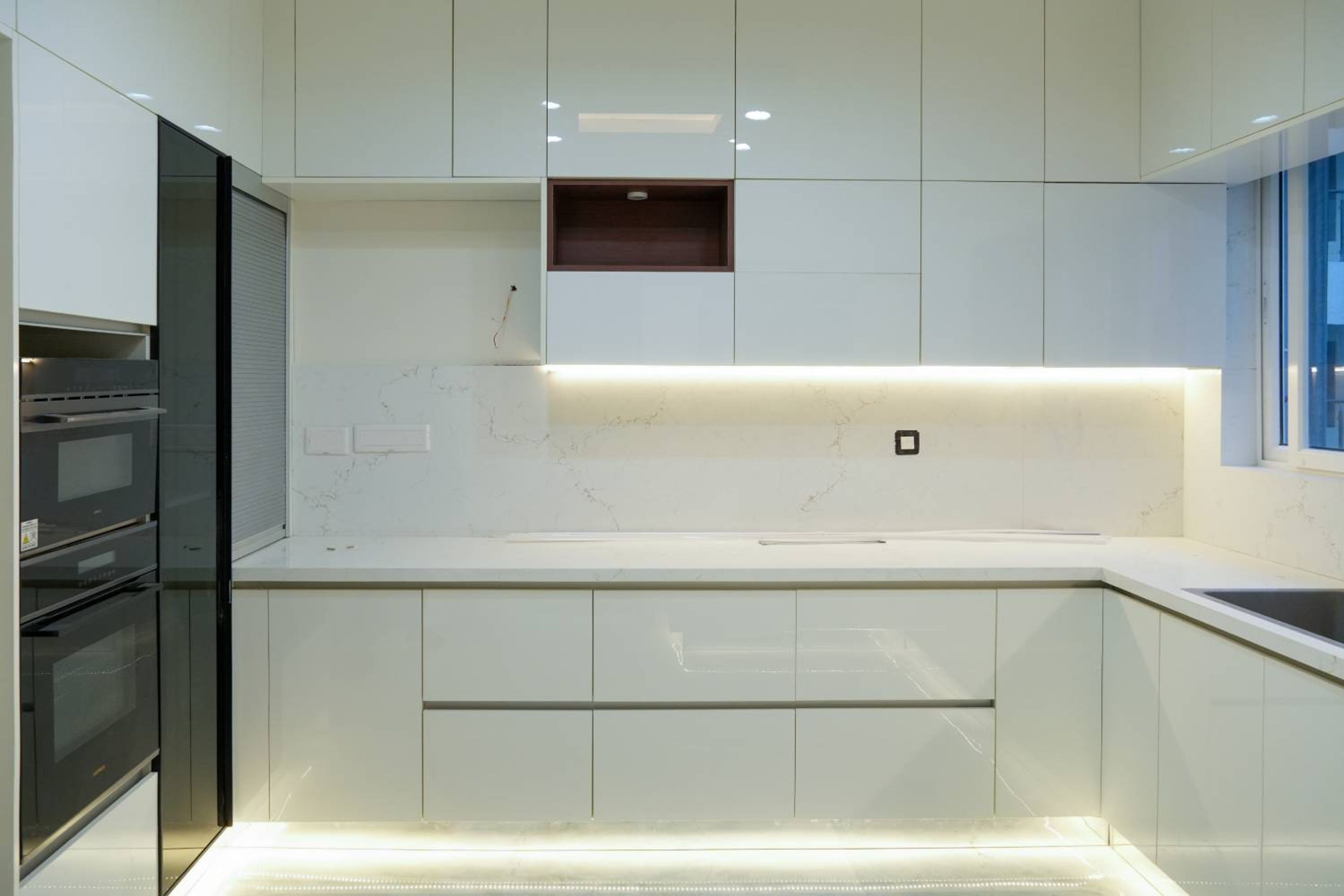 U Shaped Kitchen Design with White Glossy Cabinets and Quartz Countertop