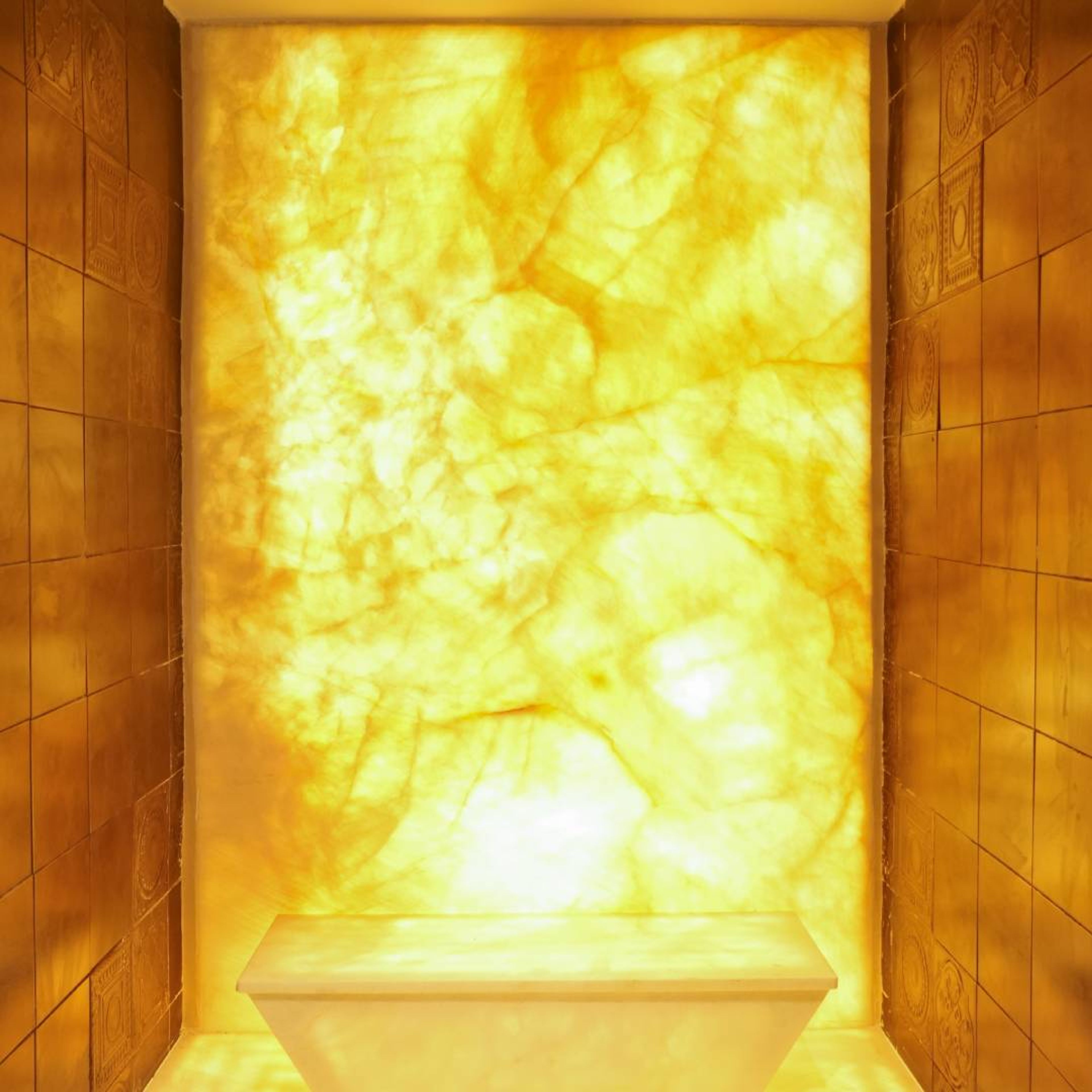 Backlit Golden Onyx Wall With Minimalist Marble Vanity And Luxurious Ambiance