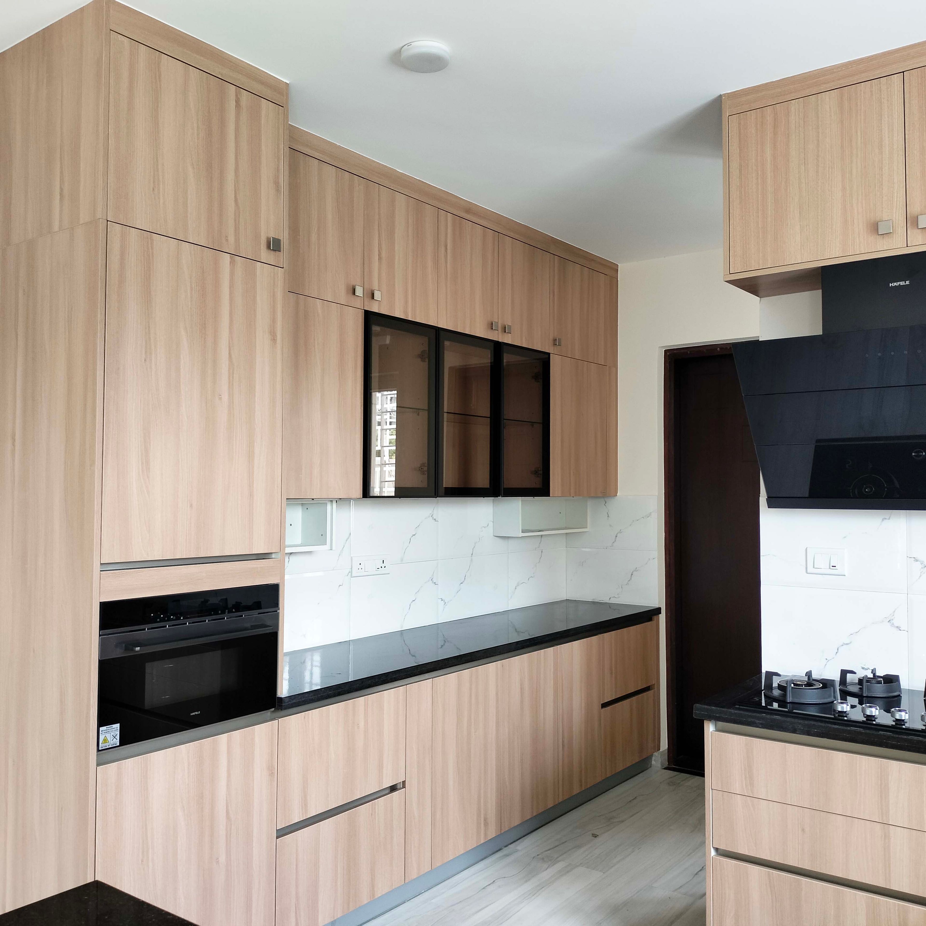 "U-Shaped Kitchen Design with Jet Black Granite Countertops U-Shaped Kitchen Design with Light Wood Cabinets"