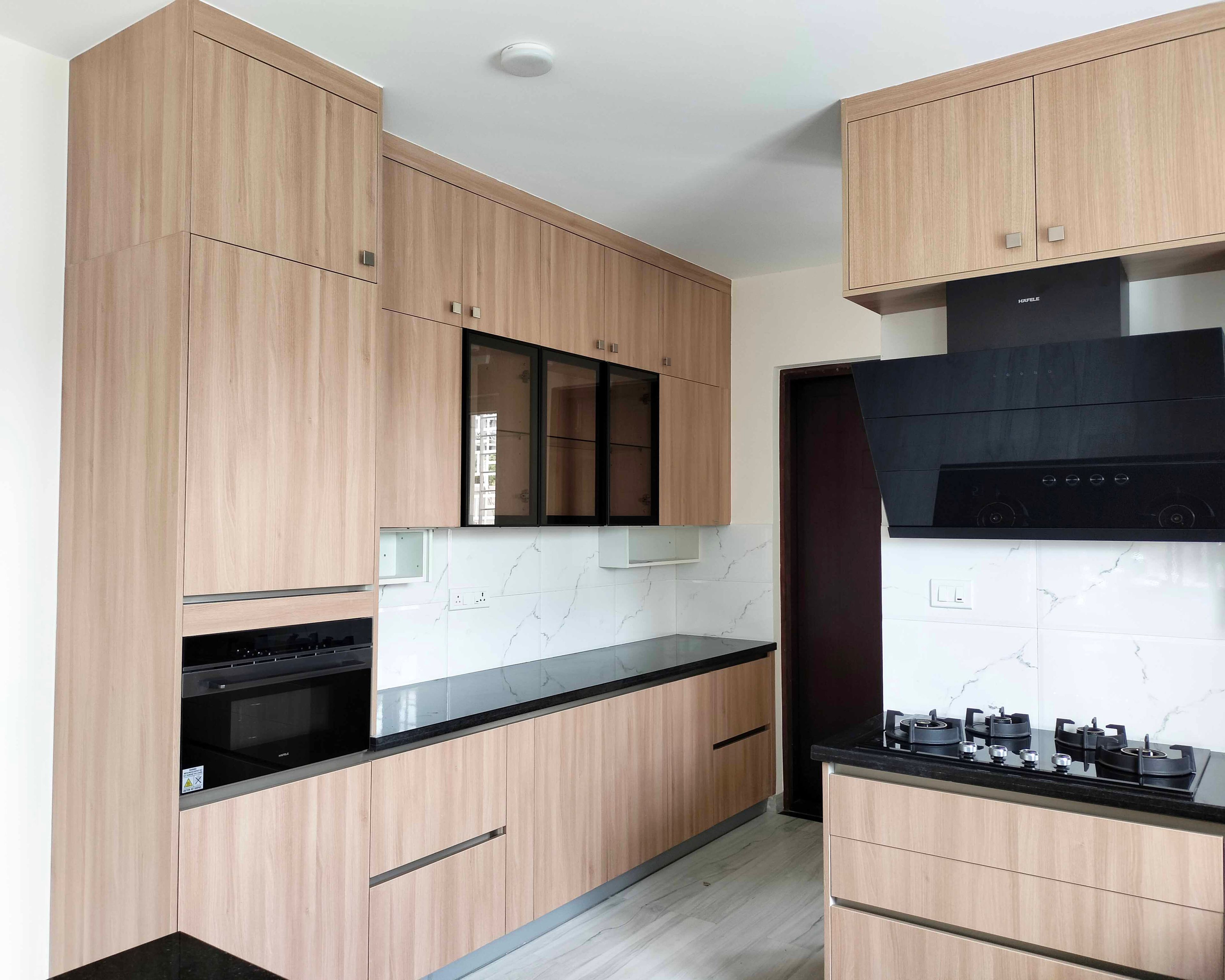 U-Shaped Kitchen Design with Wooden Units and Marble Patterned Backsplash