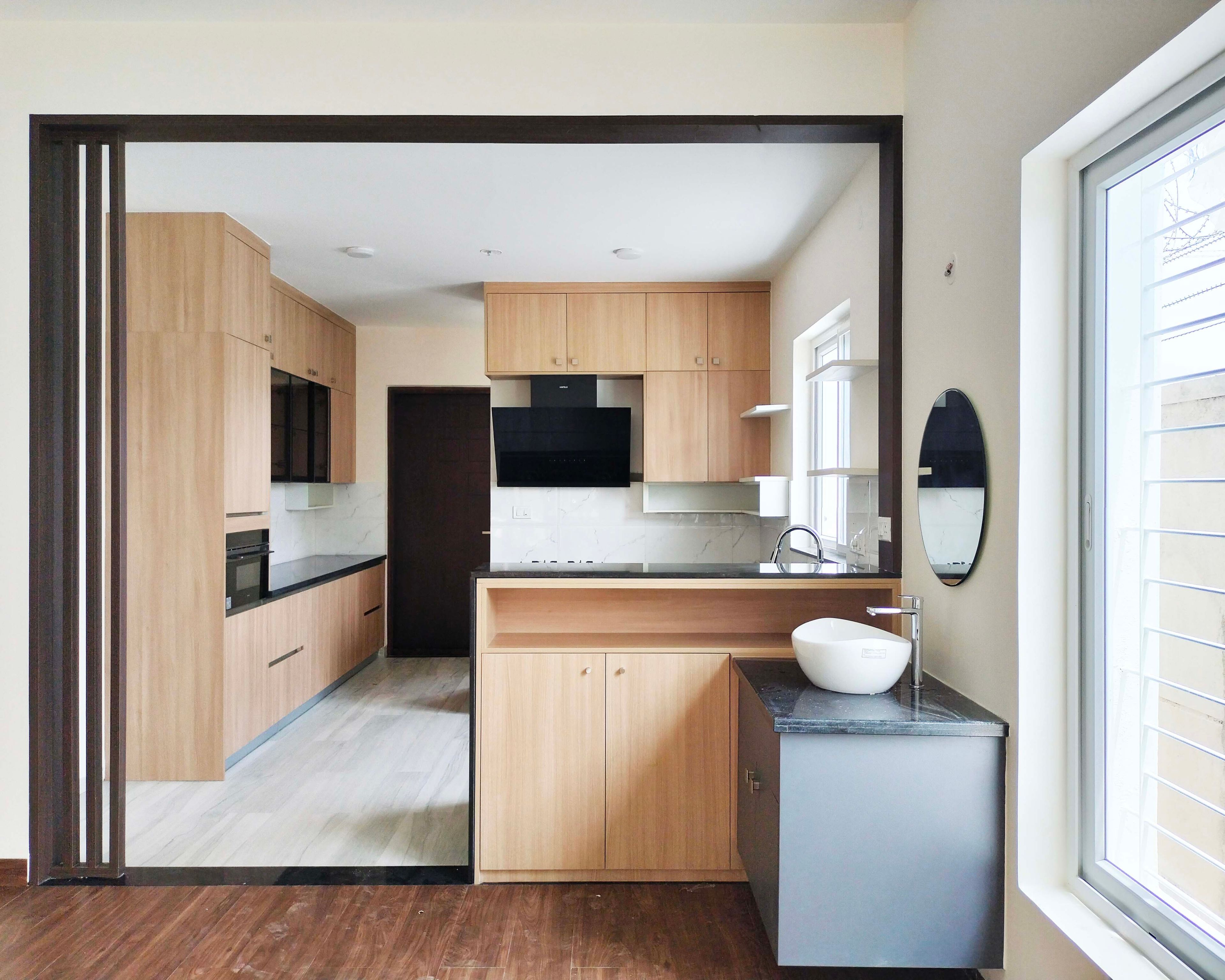 U-Shaped Kitchen Design with Granite Top Island with Wooden Units and Wash Basin with Grey Cabinets