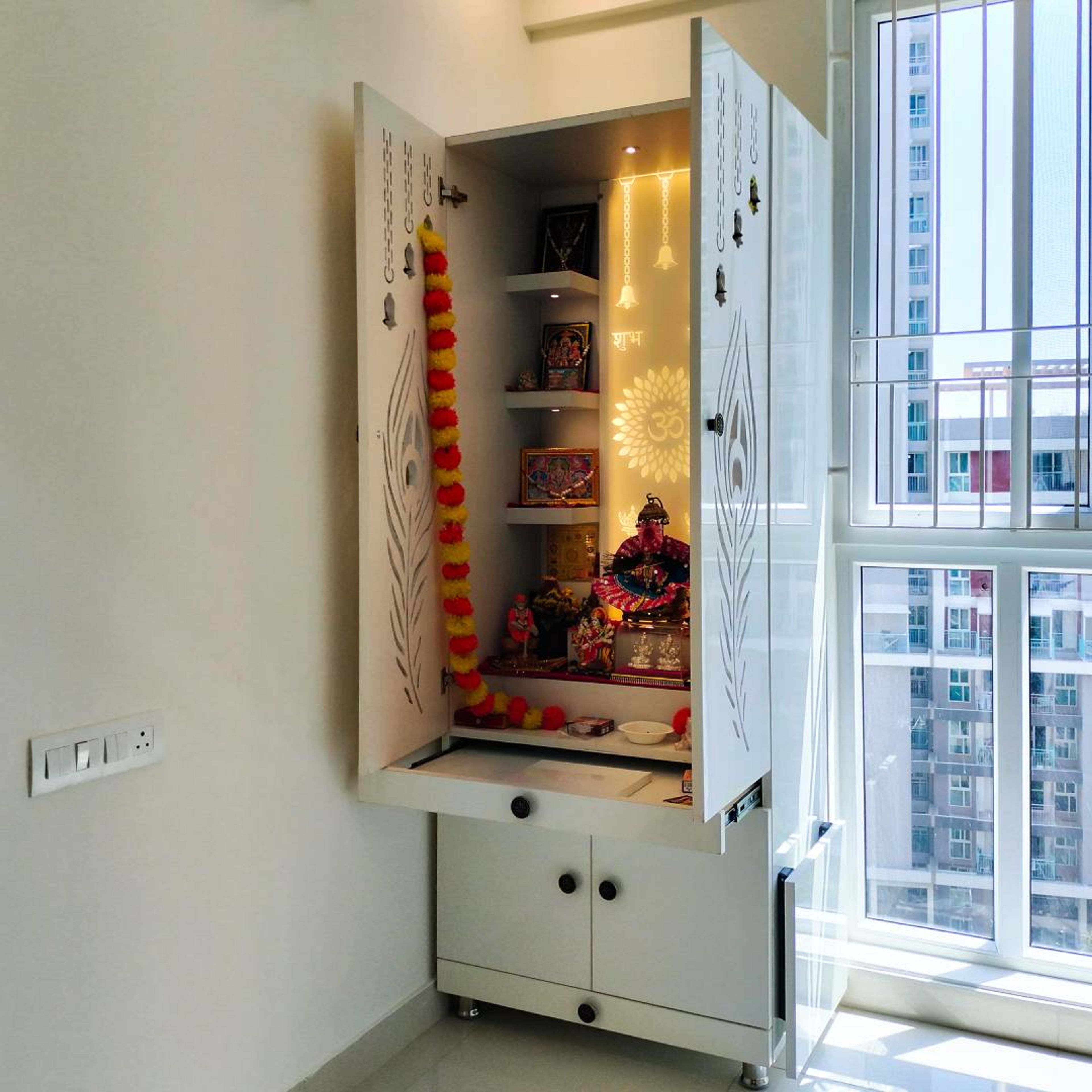 Contemporary Floor-Mounted Pooja Design With Glass Doors And Drawer Storage