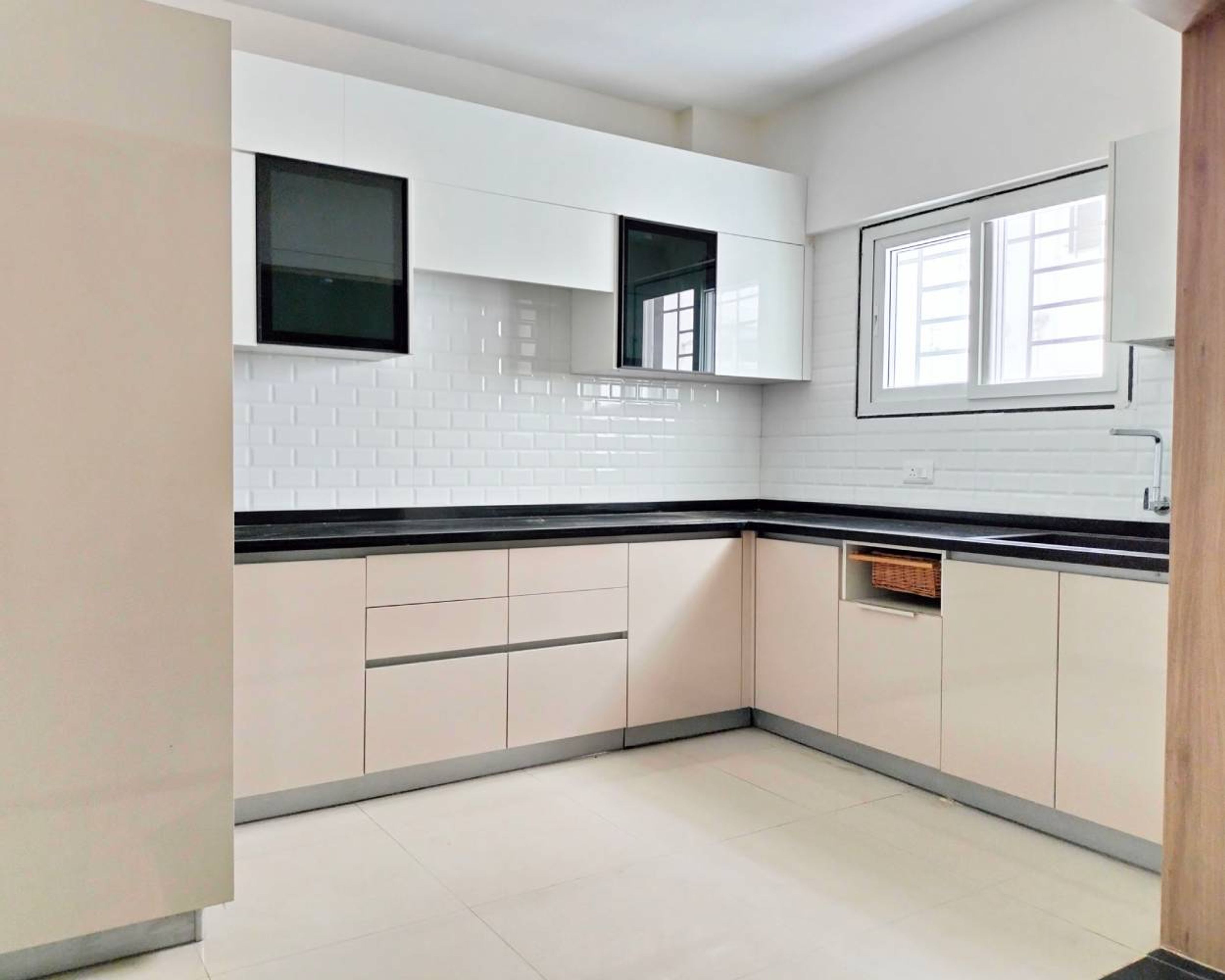 U-Shaped Kitchen Design with Beige and White Cabinets and White Brick Patterned Backsplash