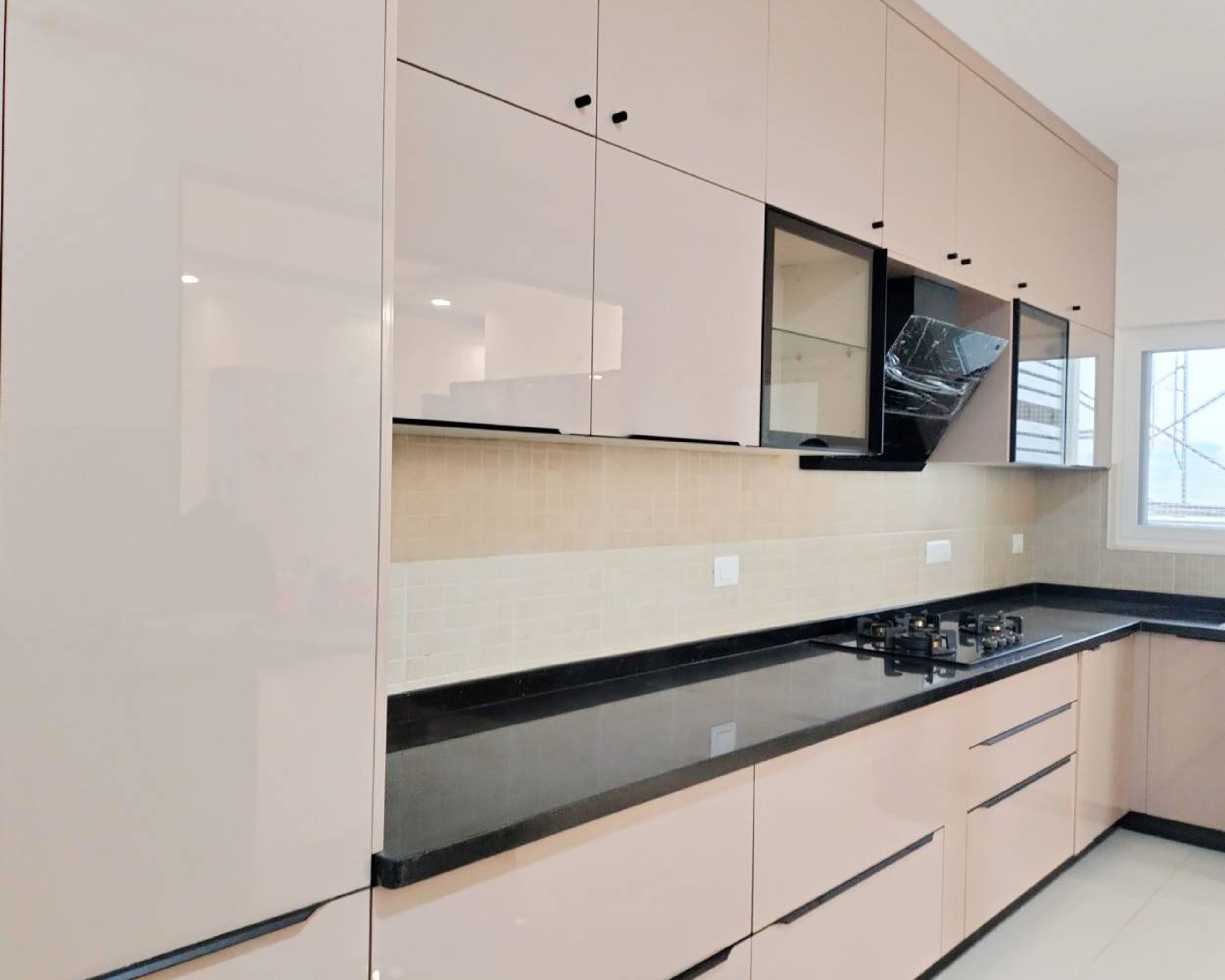 L-Shaped Kitchen Design with Peach Cabinets and Black Granite Countertop