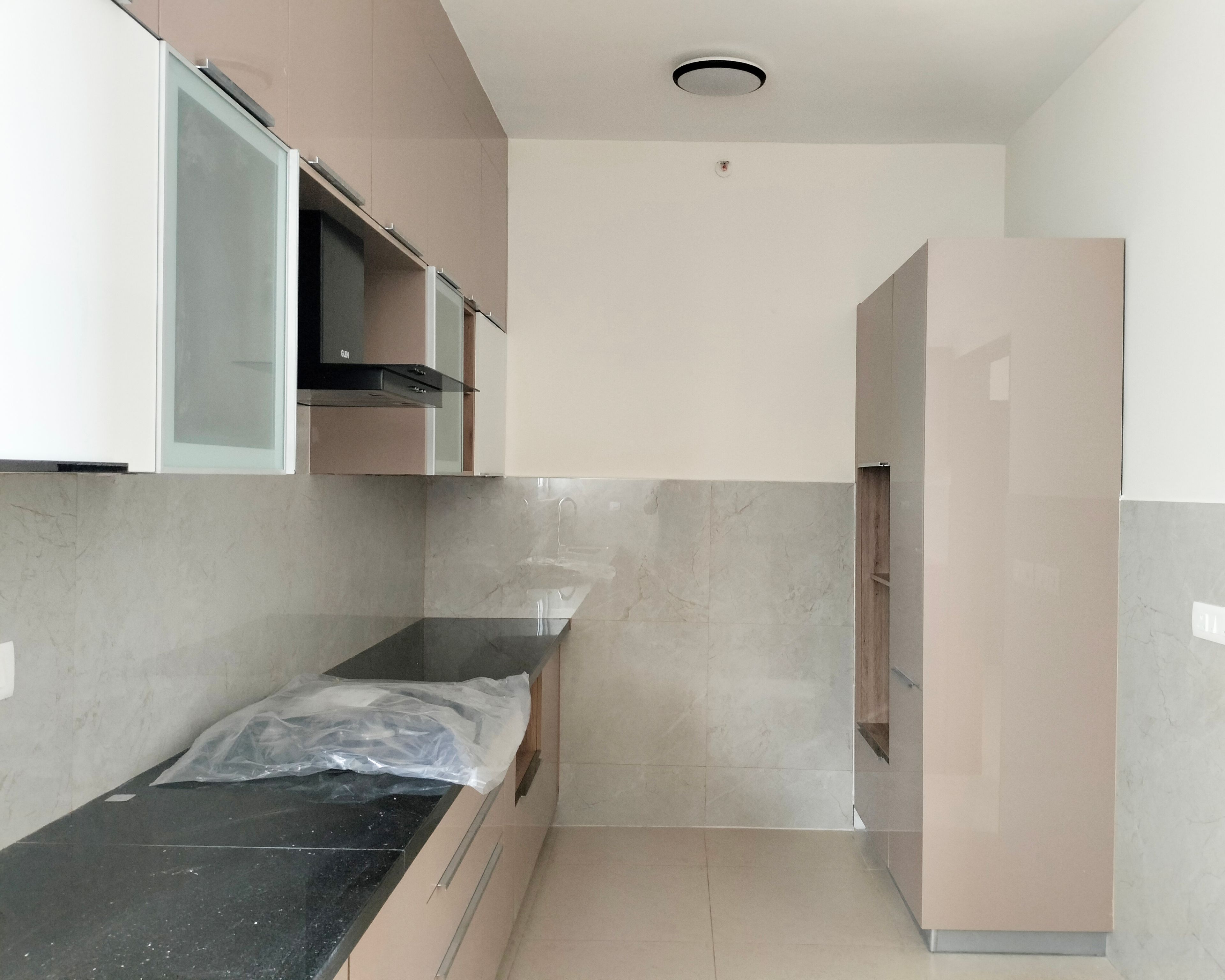 Parallel Kitchen Design with Peach Units and Granite Countertop