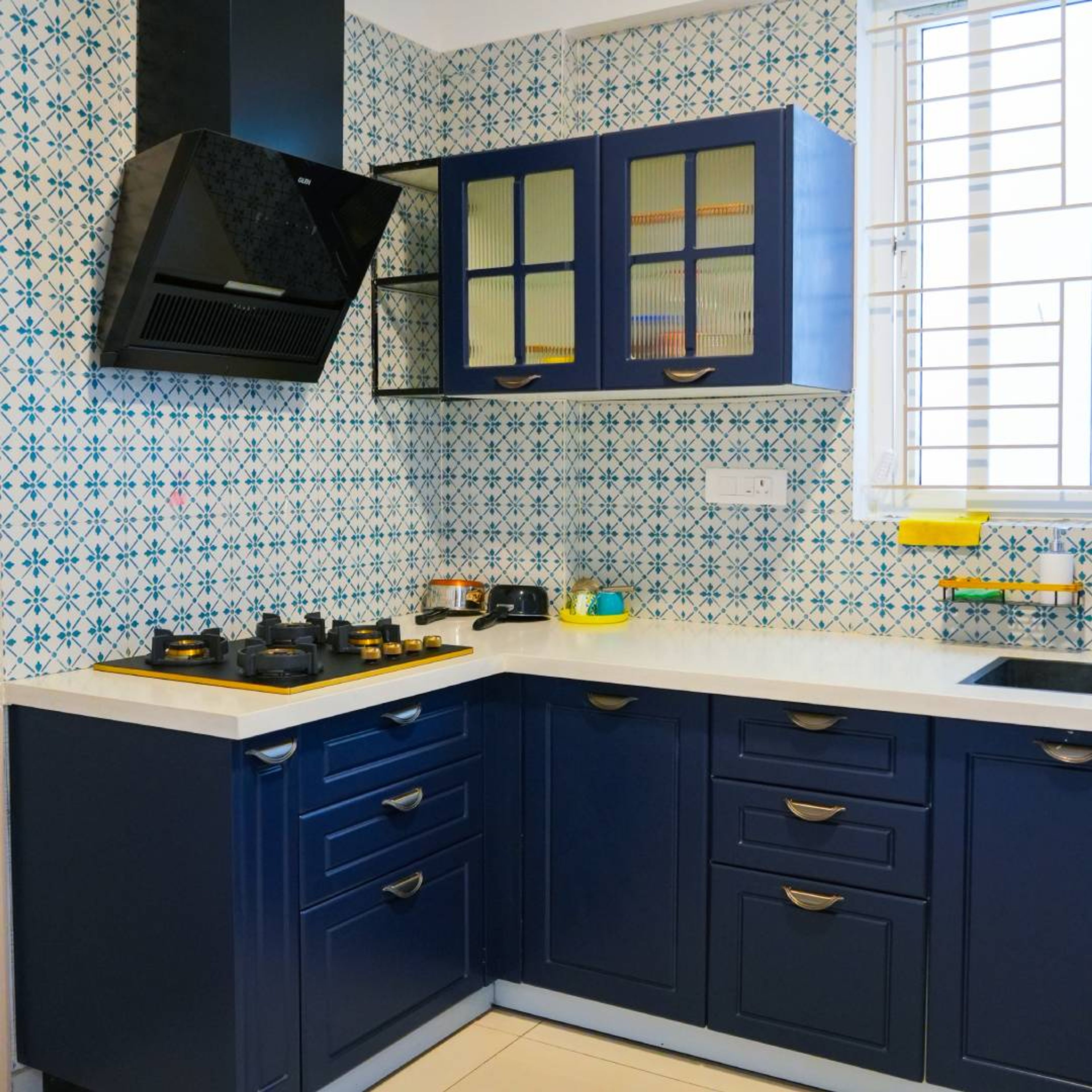 U-Shaped Kitchen Design with Blue and White Backsplash Tiles and Quartz Countertop