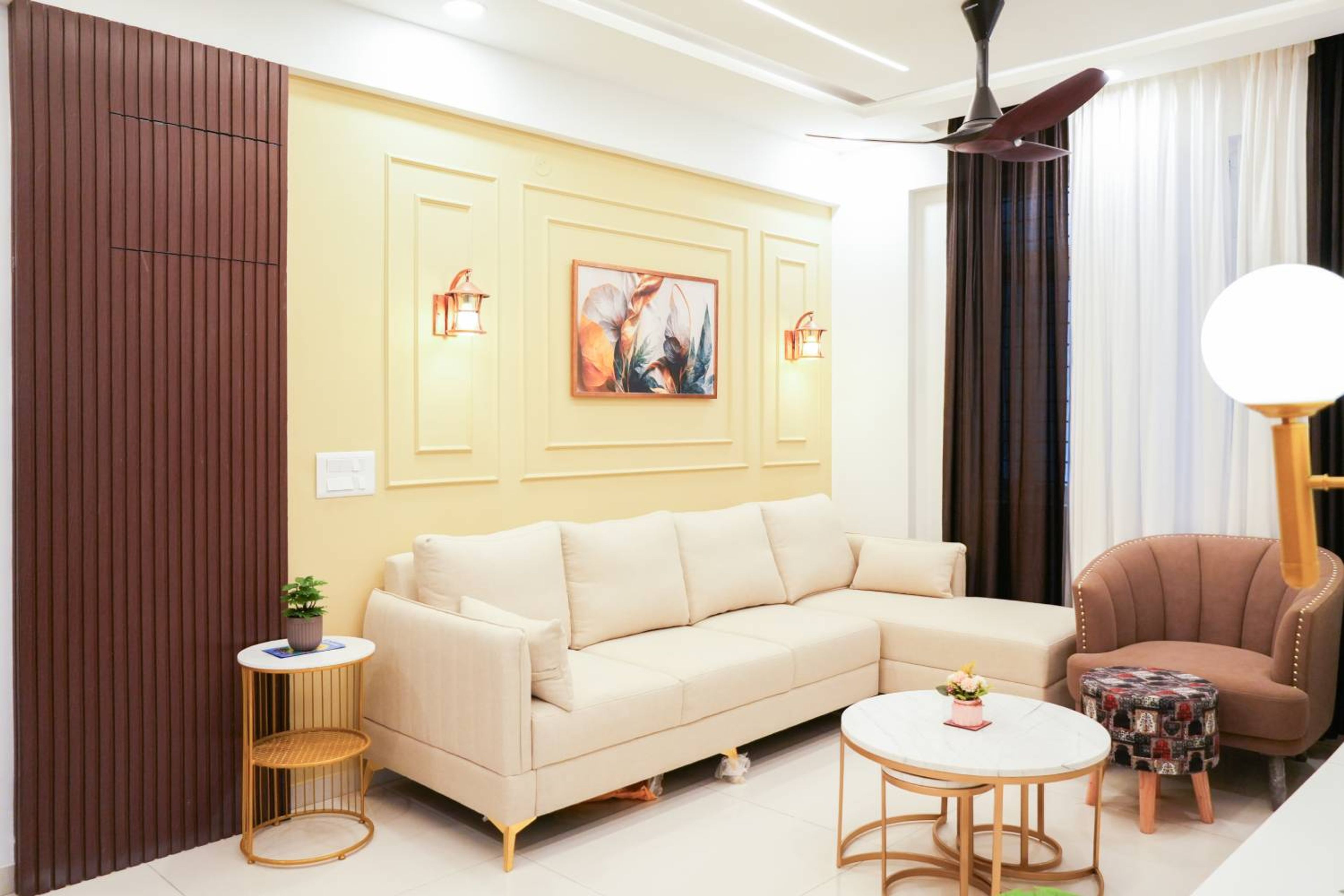 Living Room Design with Light Yellow Wall with Trims and L-Shaped off White Sofa