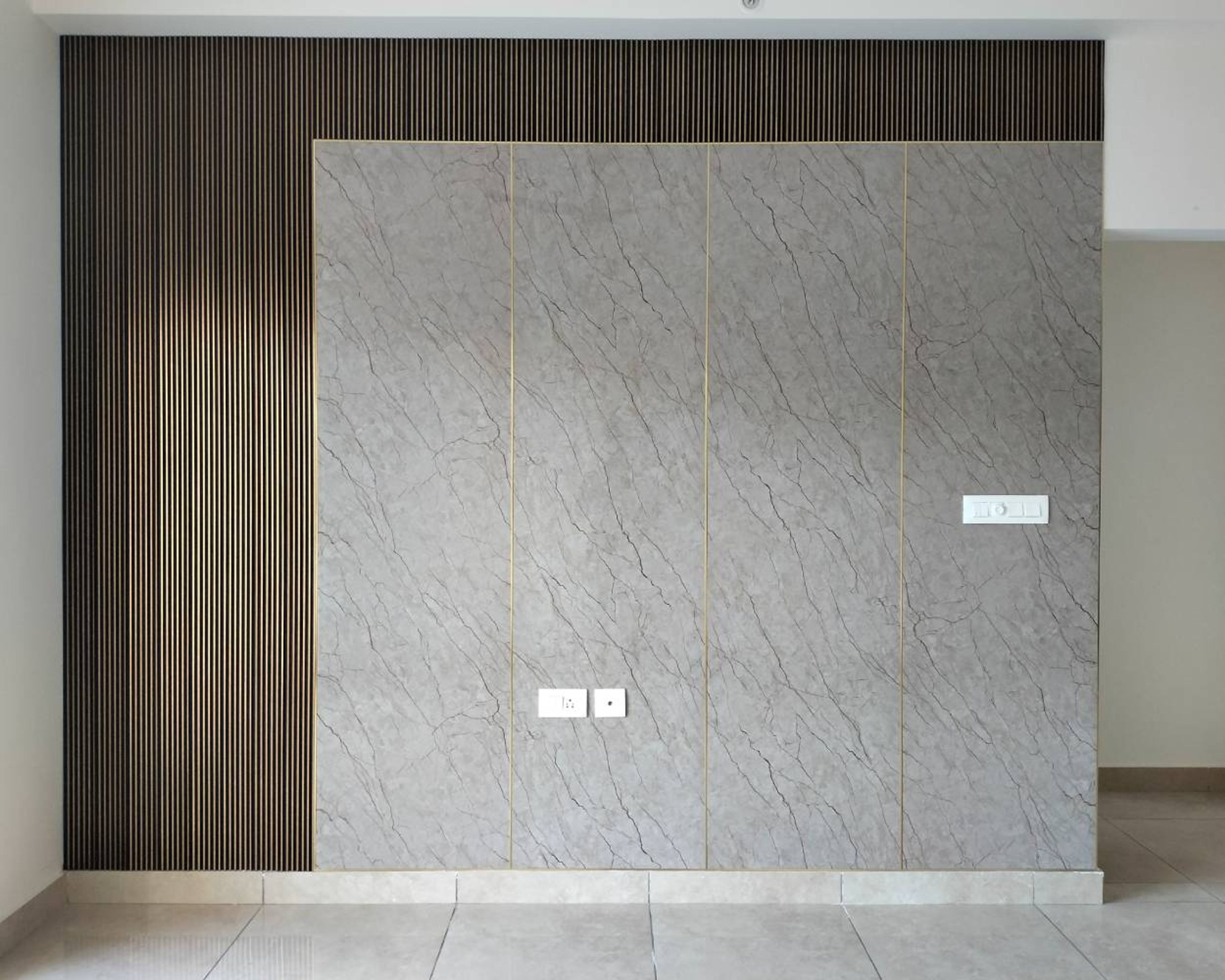 Grey Textured Wall Design with Gold Inlays and Dark Grey Fluted Wall Slats