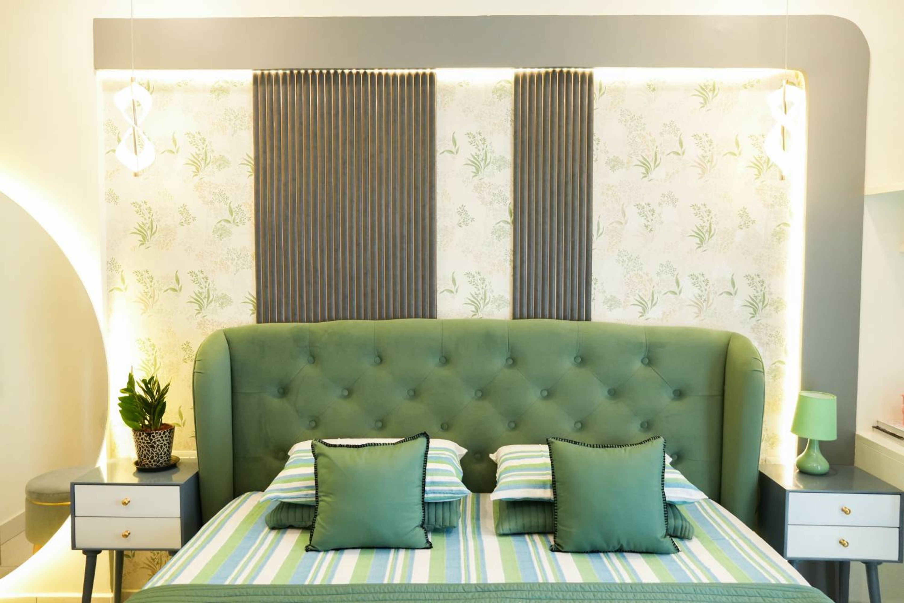 Master Bedroom Design with Green Upholstered Bed and Wallpaper Panel with Vertical Stripes
