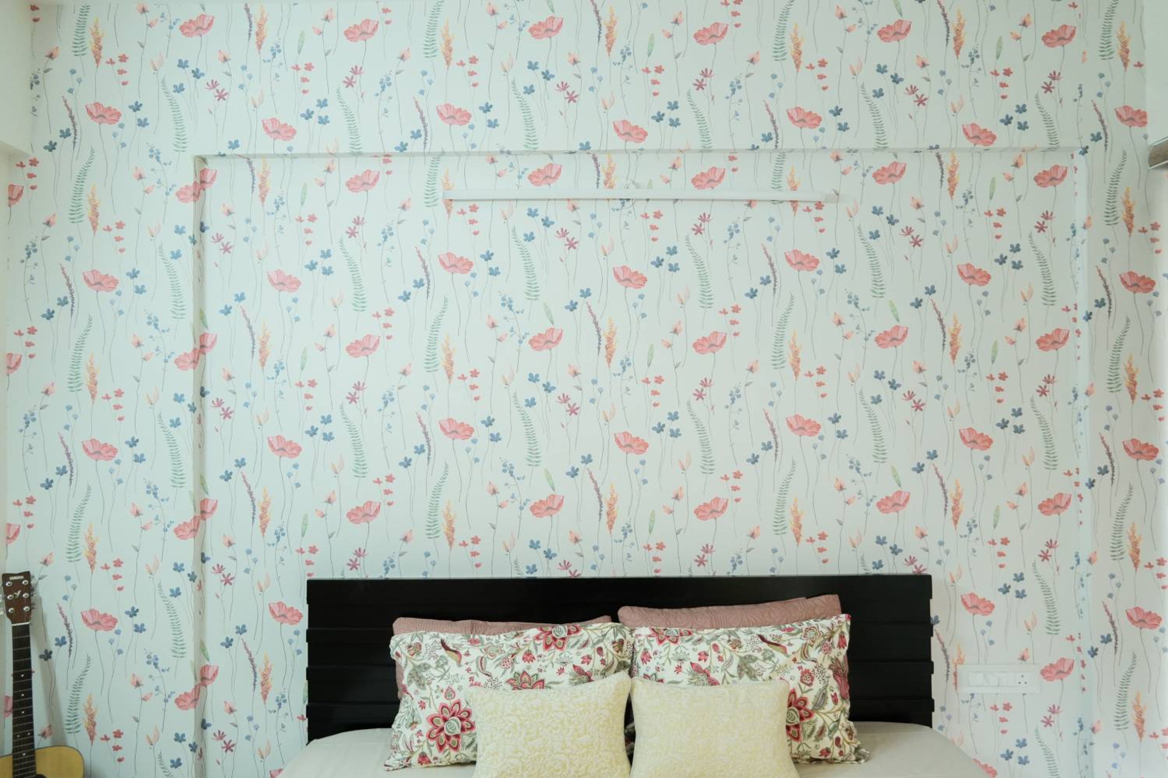 Wallpaper Design with Pink and Green Floral Pattern behind Bed
