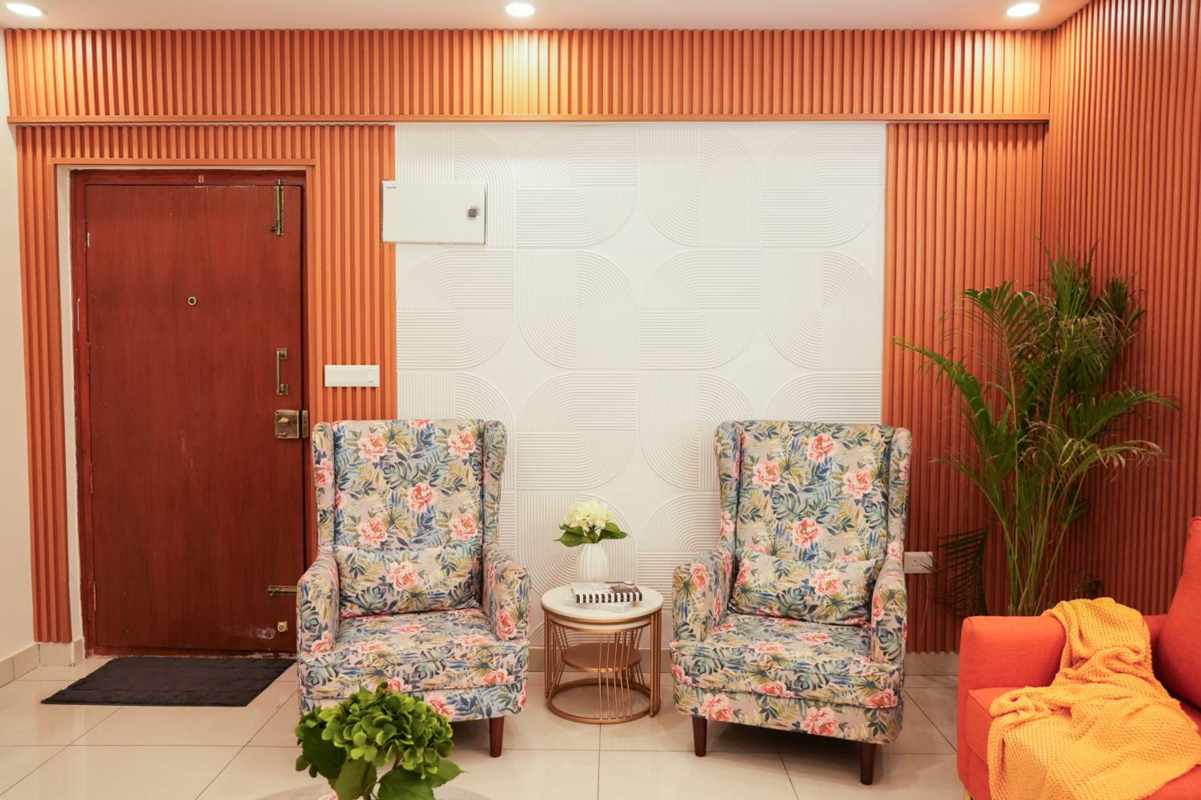 Entrance Wall Design with Floral Armchairs and Wooden Slatted Panels