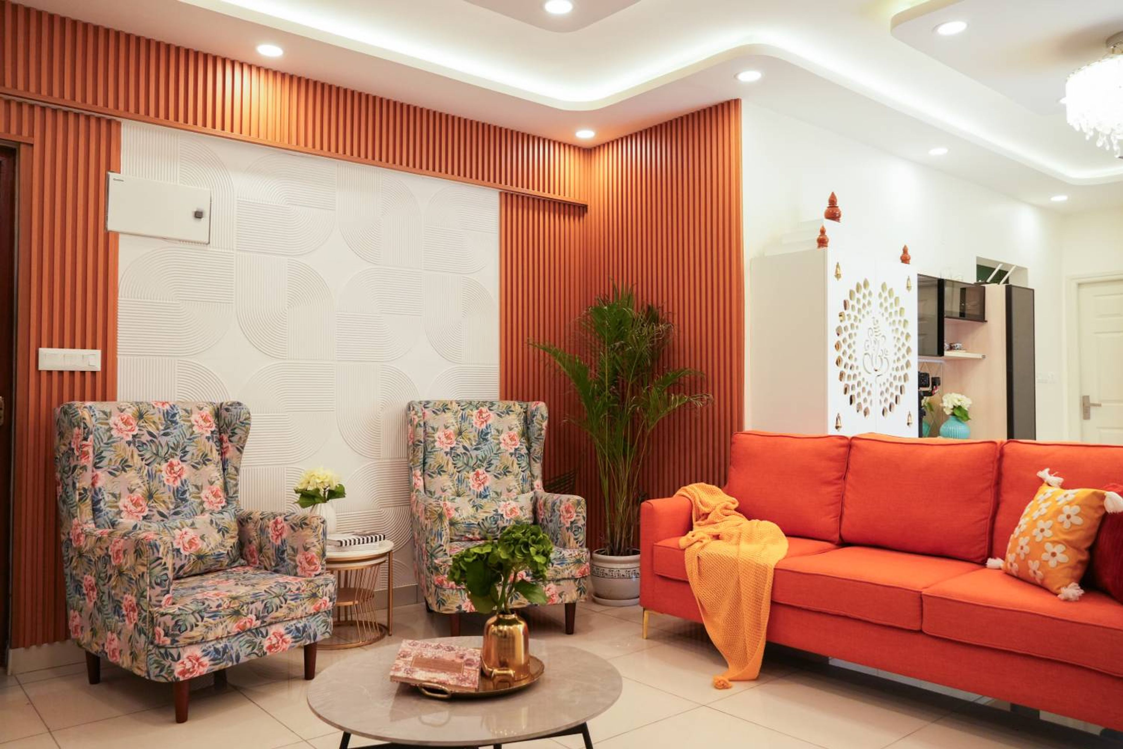 Living Room Design with Orange Sofa, Floral Accent Chairs and Wooden Slatted Wall Panels