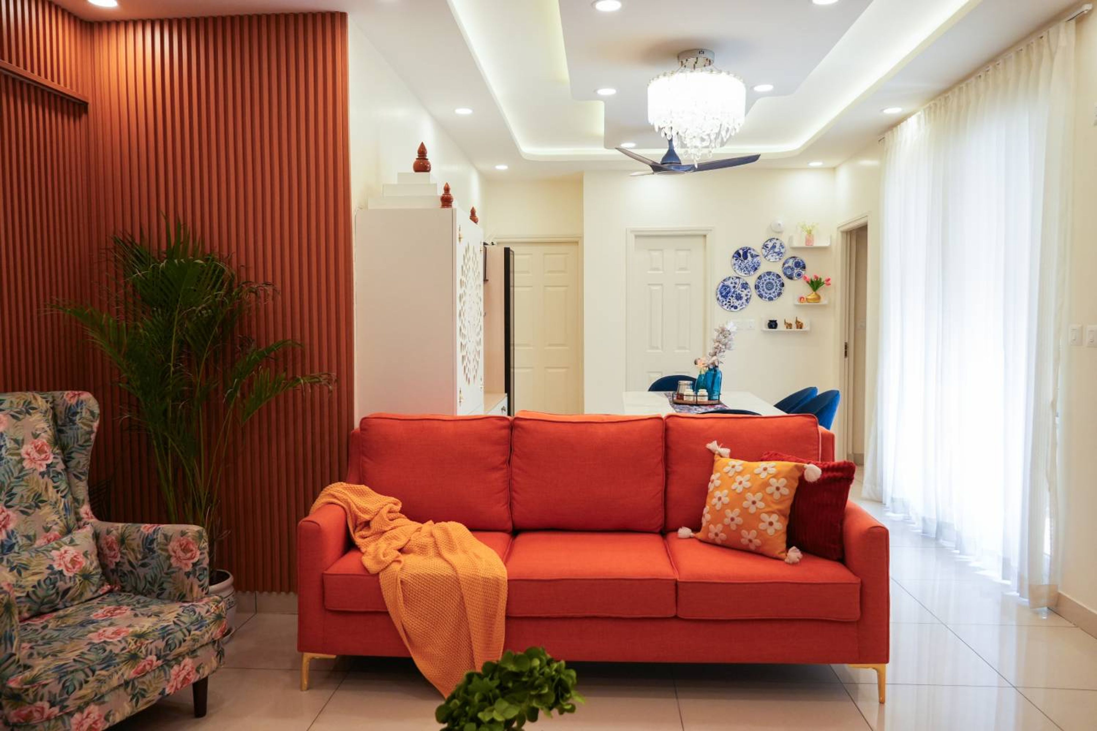 Living Room Design with Rust Orange Sofa and Floral Accent Chair