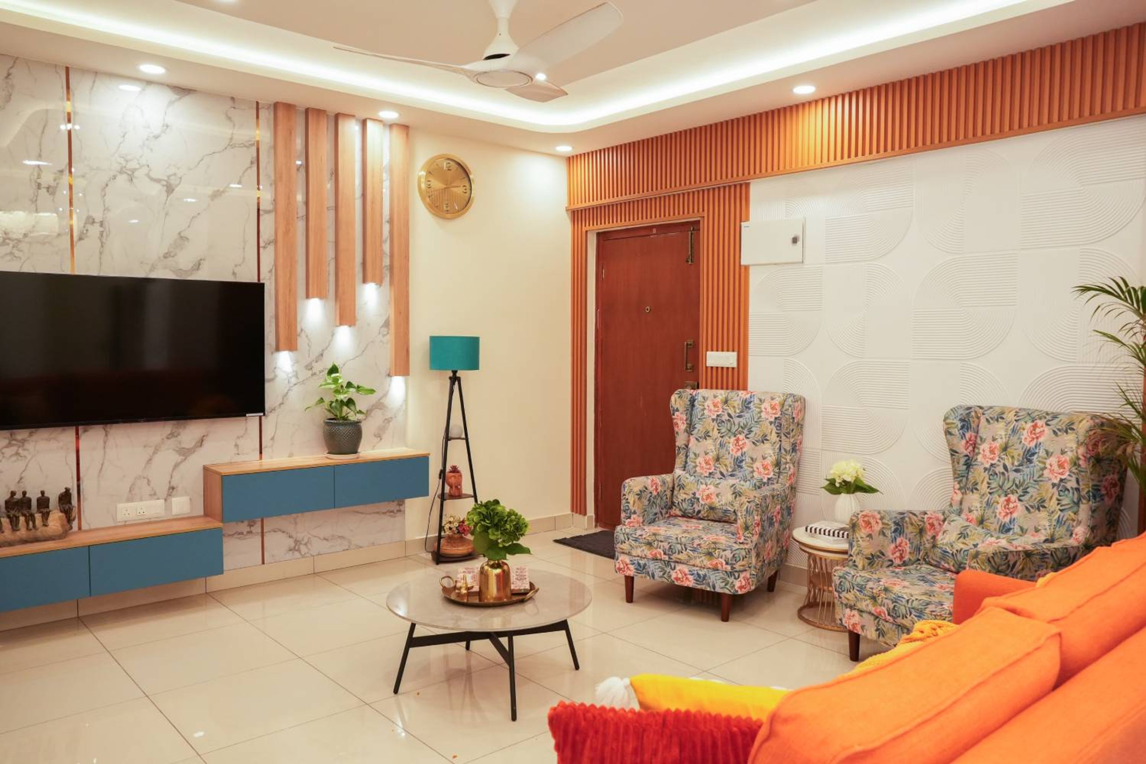 Living Room Design with Blue Floating TV Unit and Marble Wall Panels