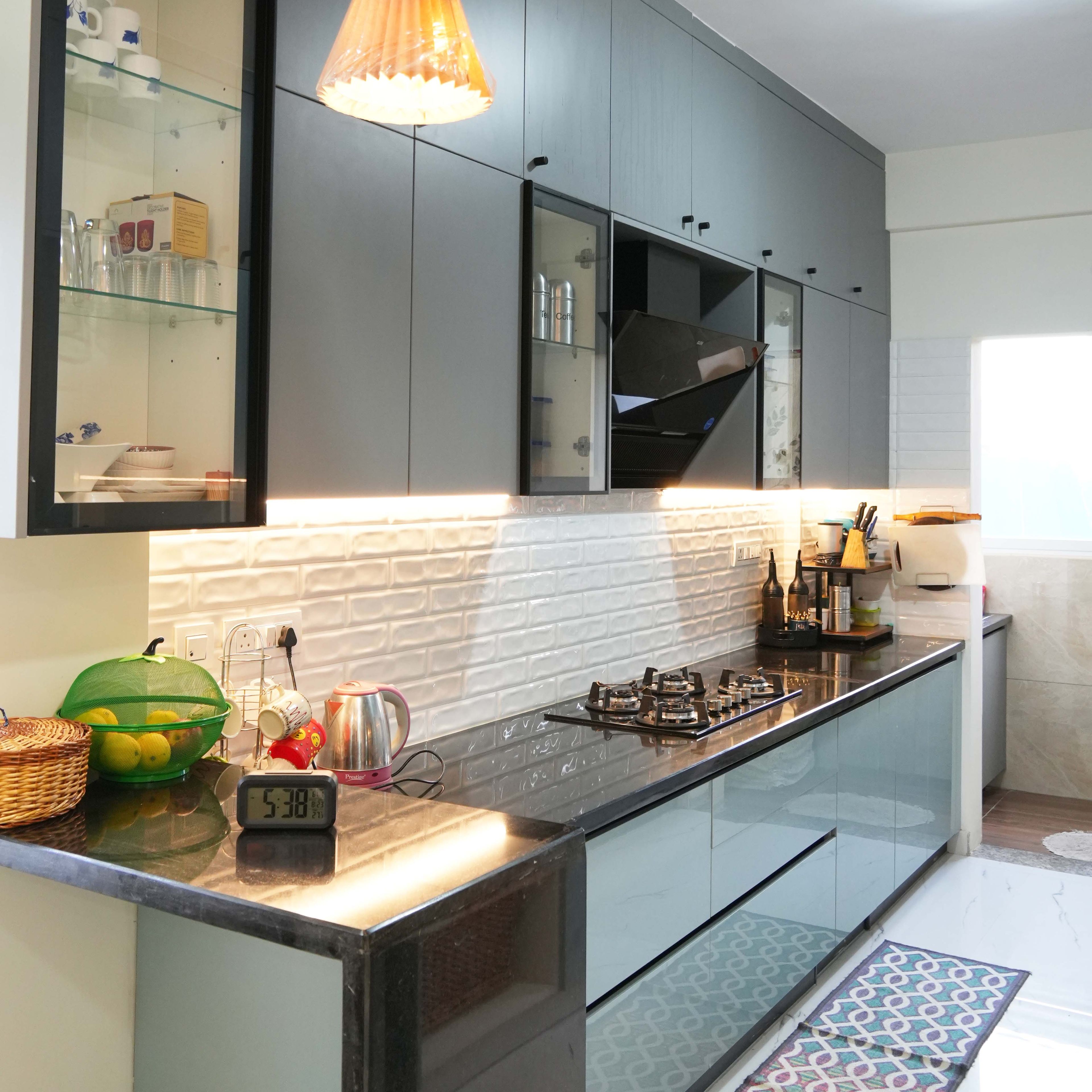 Parallel Kitchen Design with Grey and Light Blue Units, Under Cabinet Lighting, Granite Countertop and White Brick Pattern Backsplash