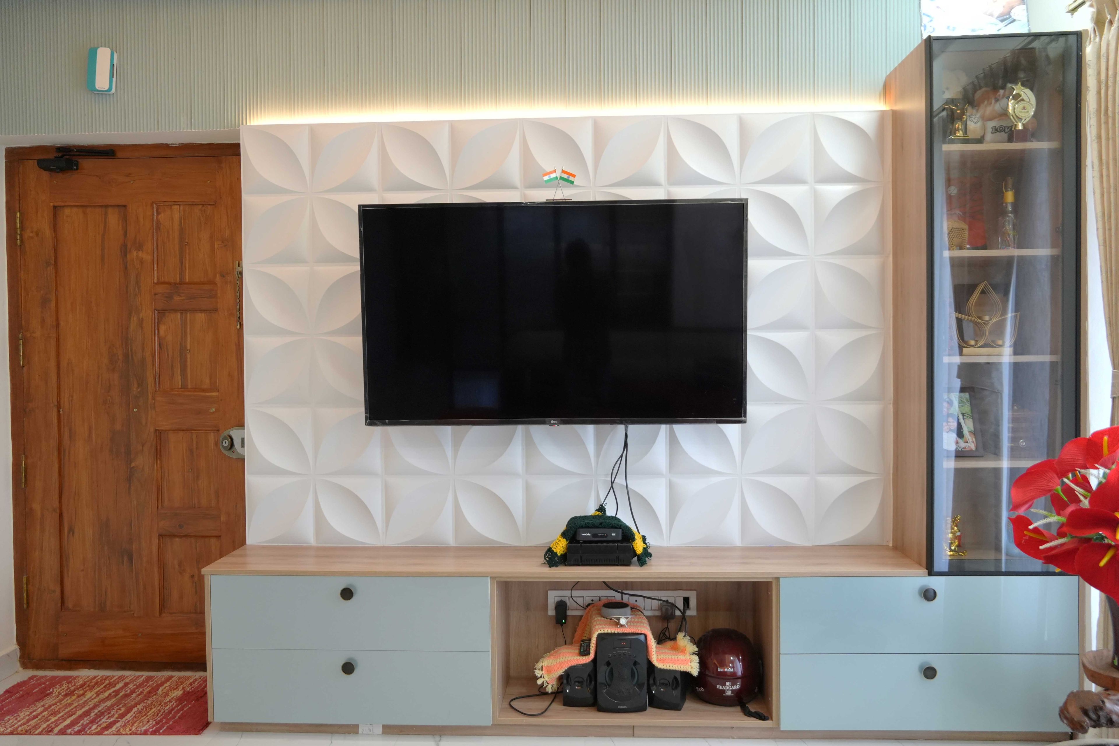 White Floral Textured Backsplash TV Unit Design with Blue Drawers and Glass Tall Unit