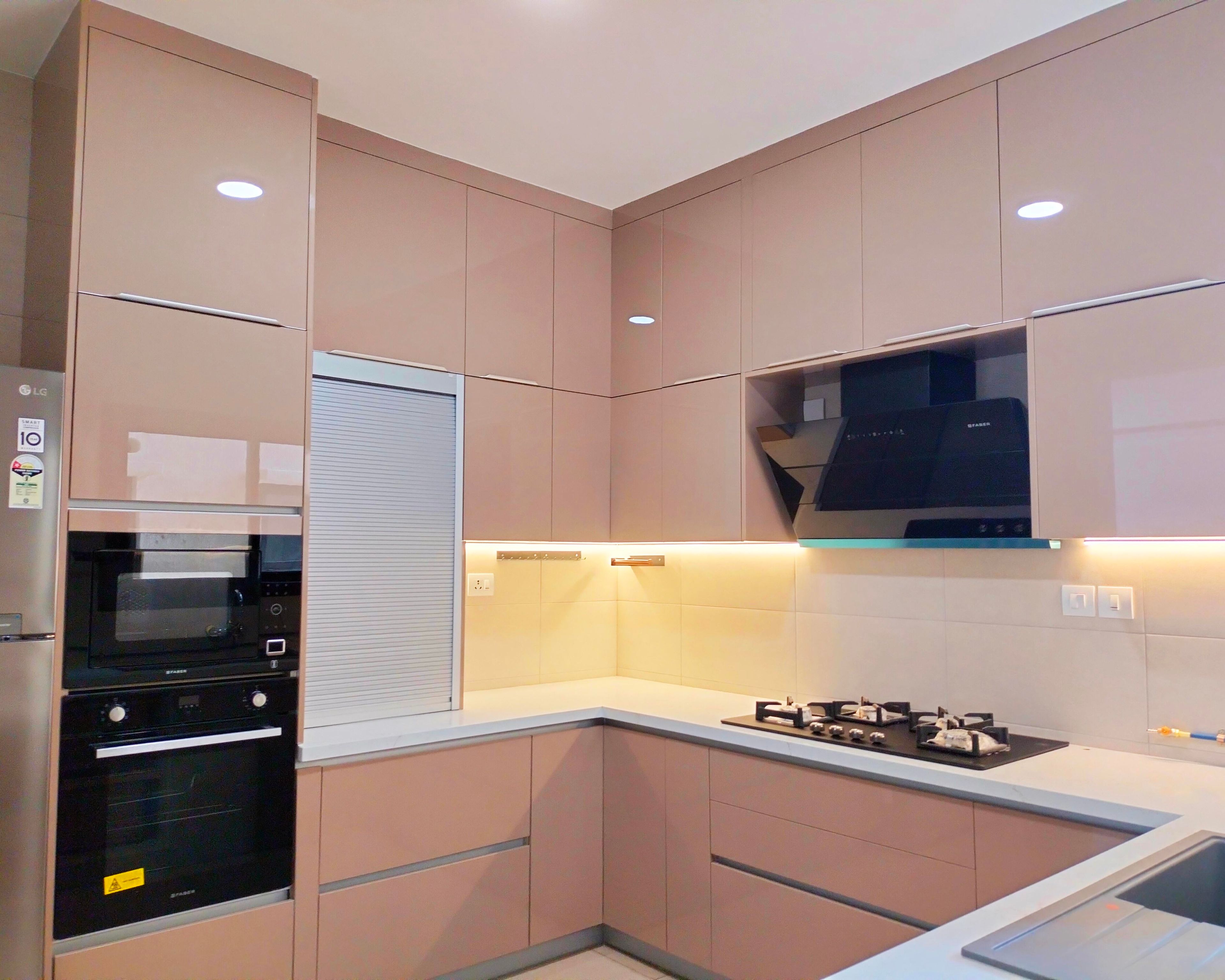 U-Shaped Kitchen Design with Peach Glossy Cabinets and White Countertop