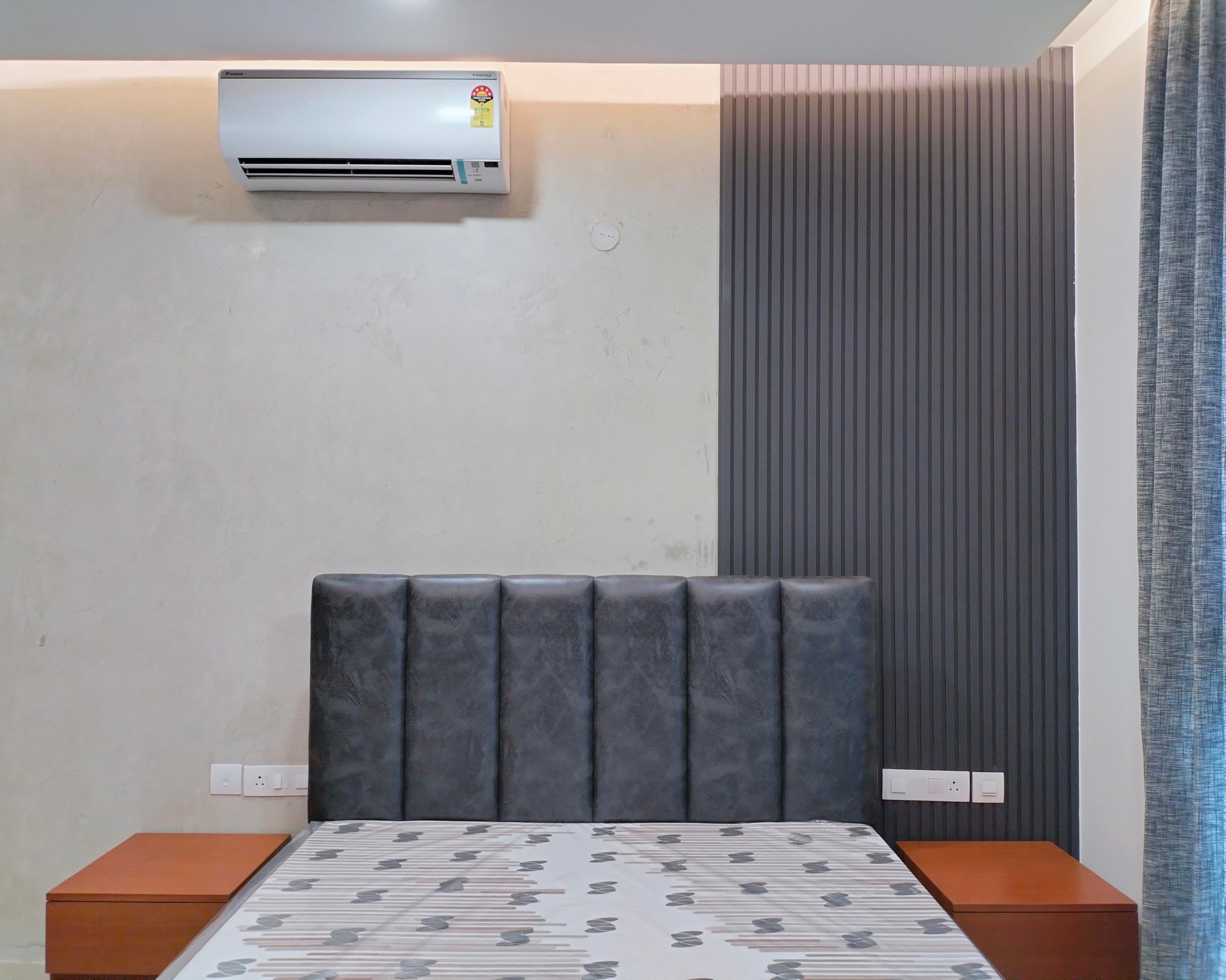 Bedroom Design with Grey Wall Slats and Grey Cushioned Headboard Bed