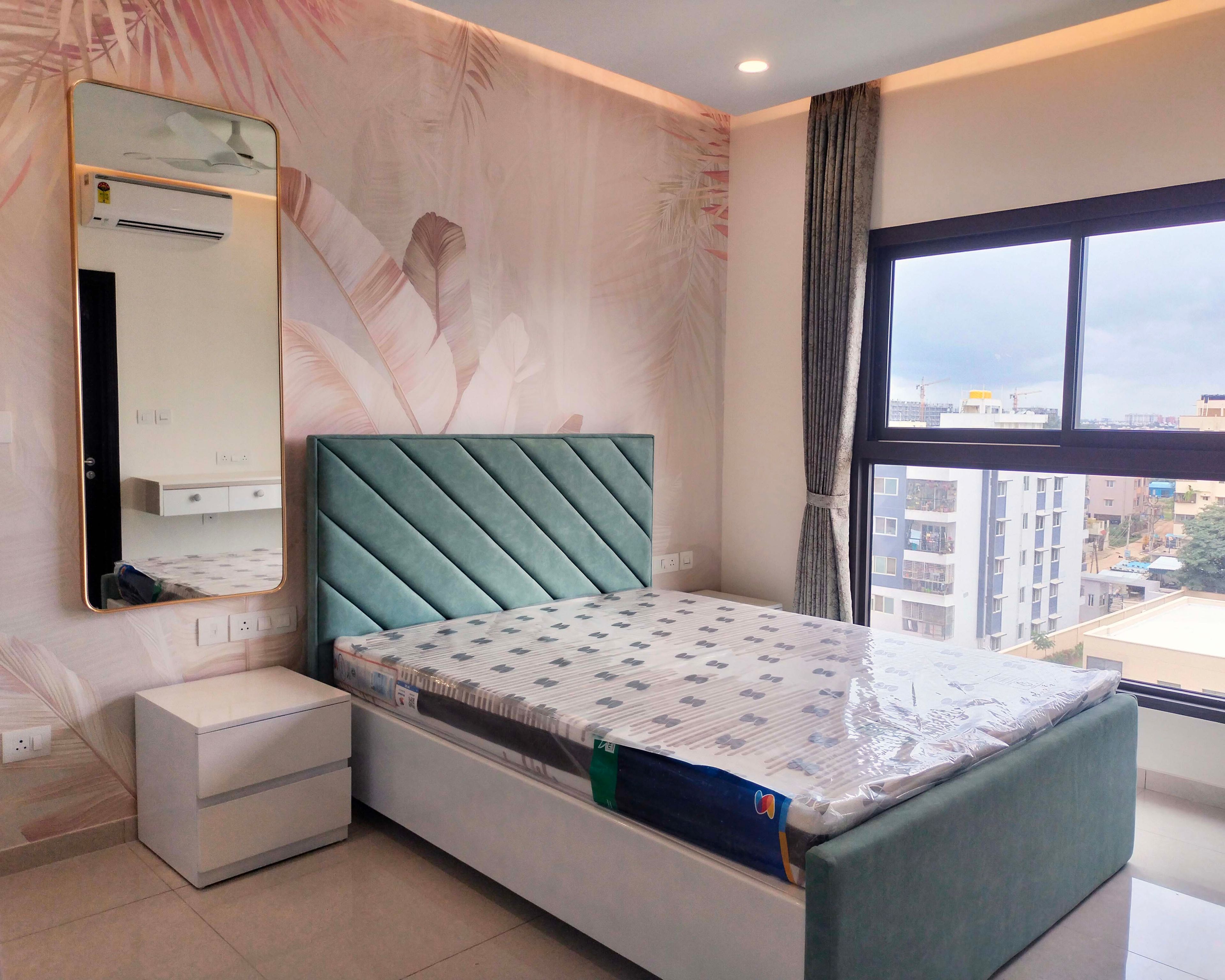 Bedroom design with tropical themed pink wall and mirror