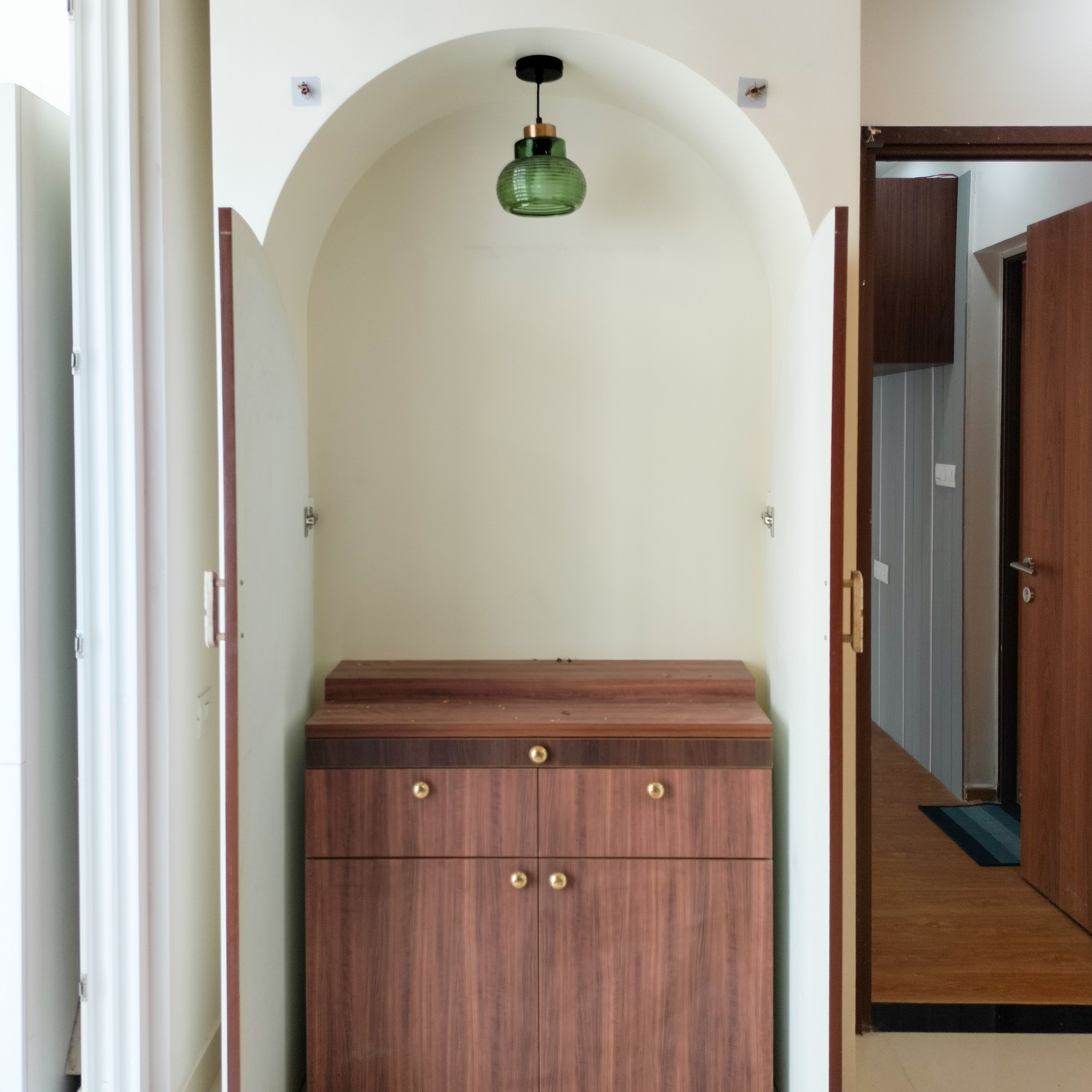 Pooja Unit Design with Wooden Cabinets and Wooden Doors