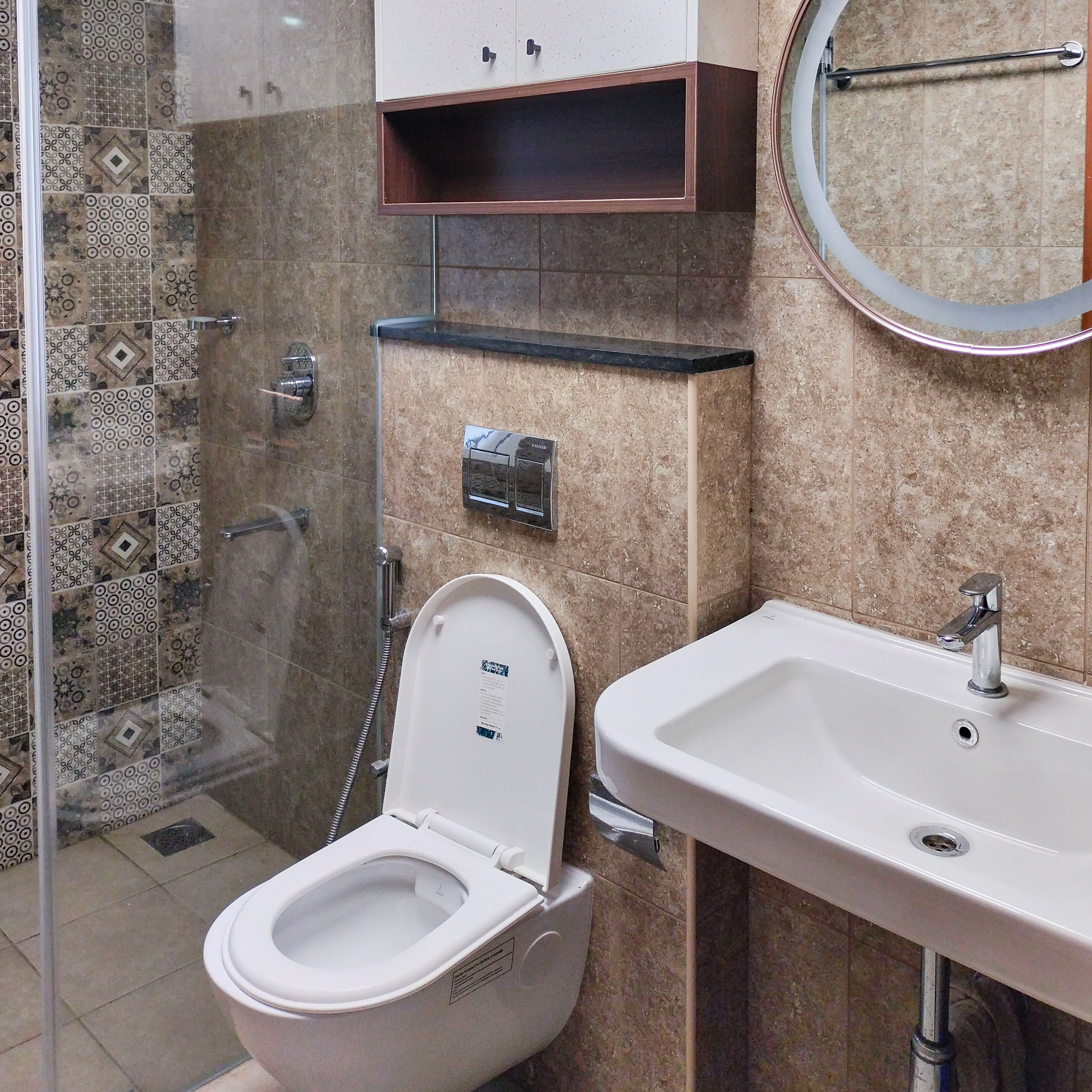 Bathroom Design with Brown Textured Tiles and Glass Partition Shower Area
