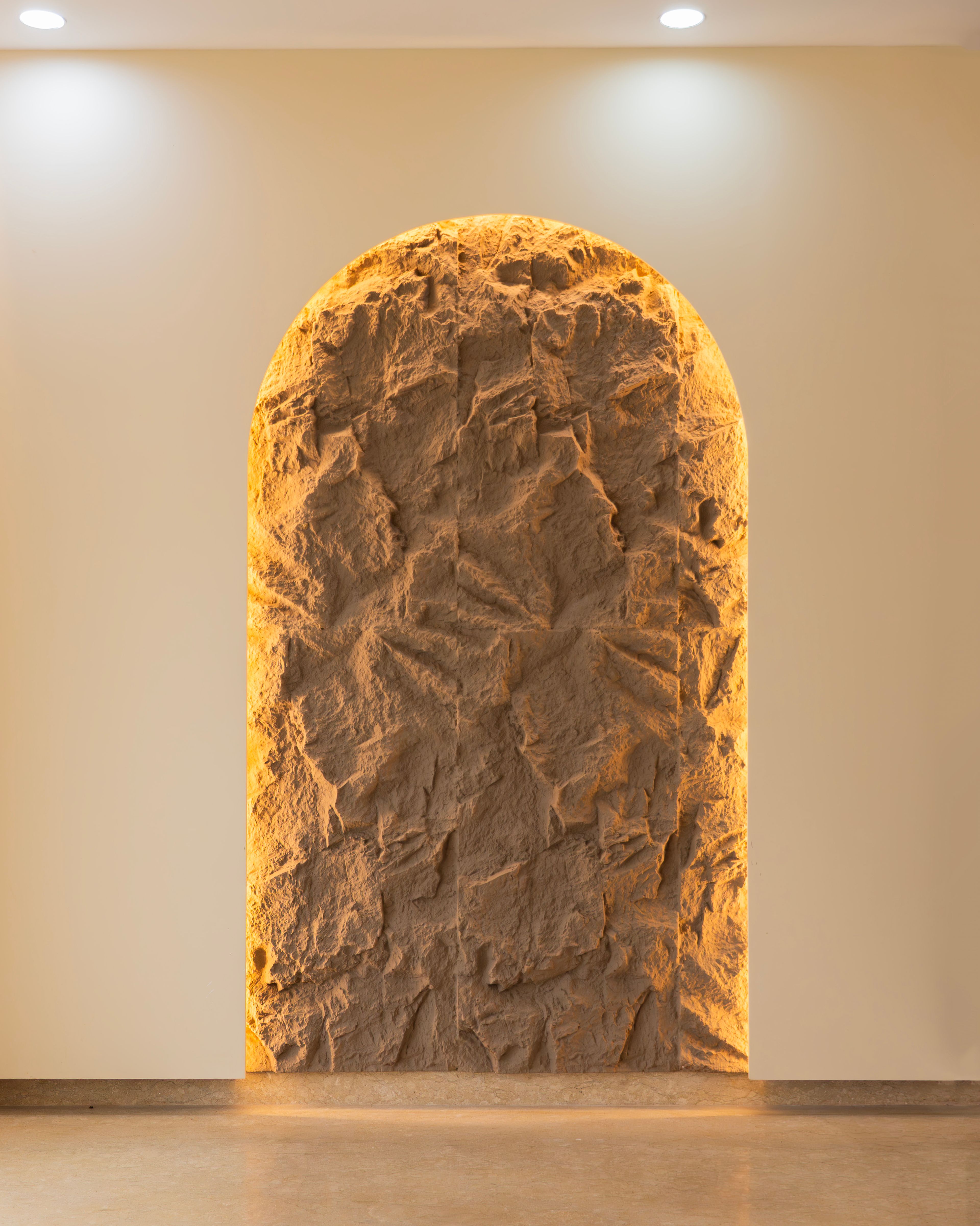 Wall Decor Design with Arched Stone Texture and Warm Lighting
