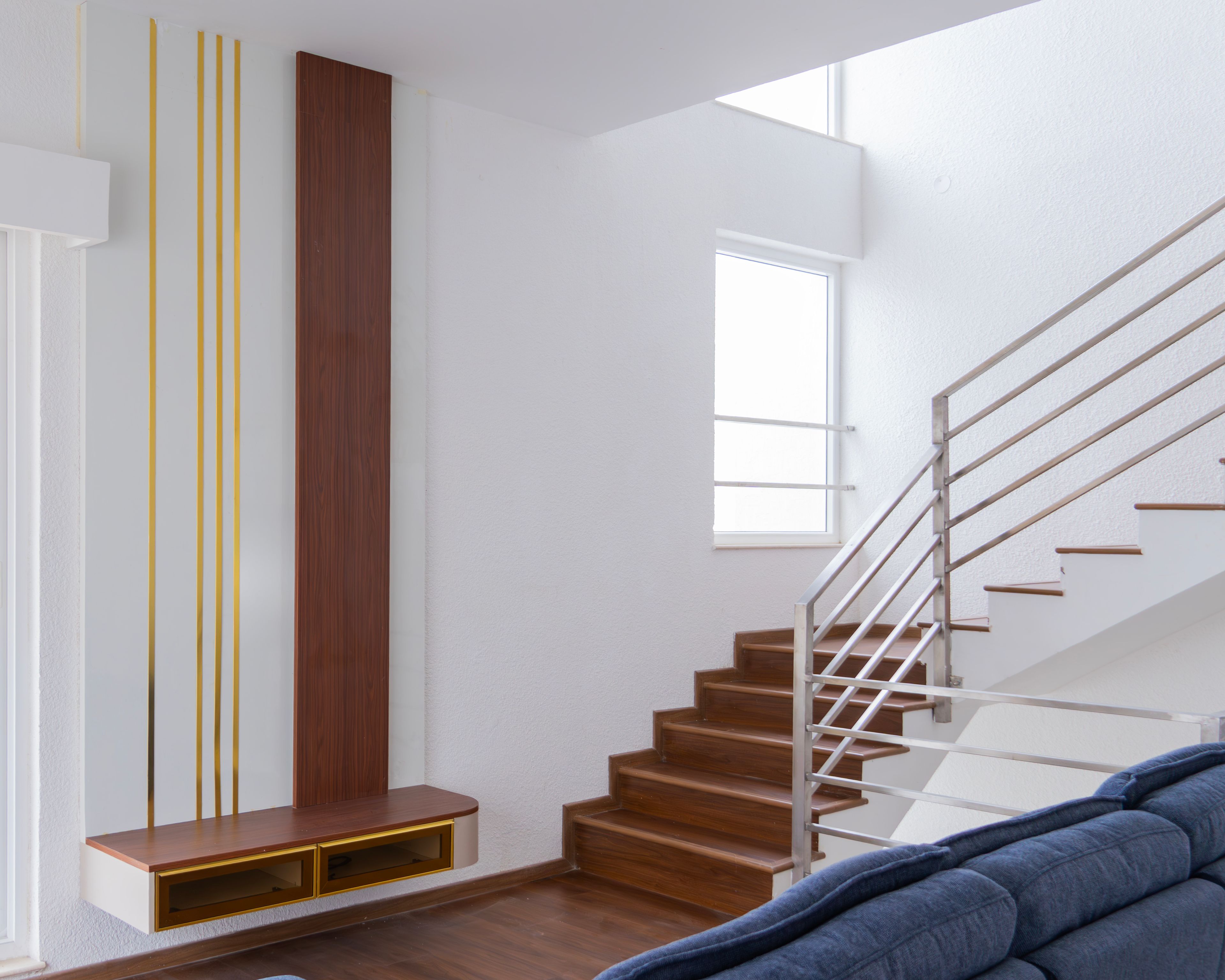 TV Unit Design with White and Wooden Wall Panel beside Staircase
