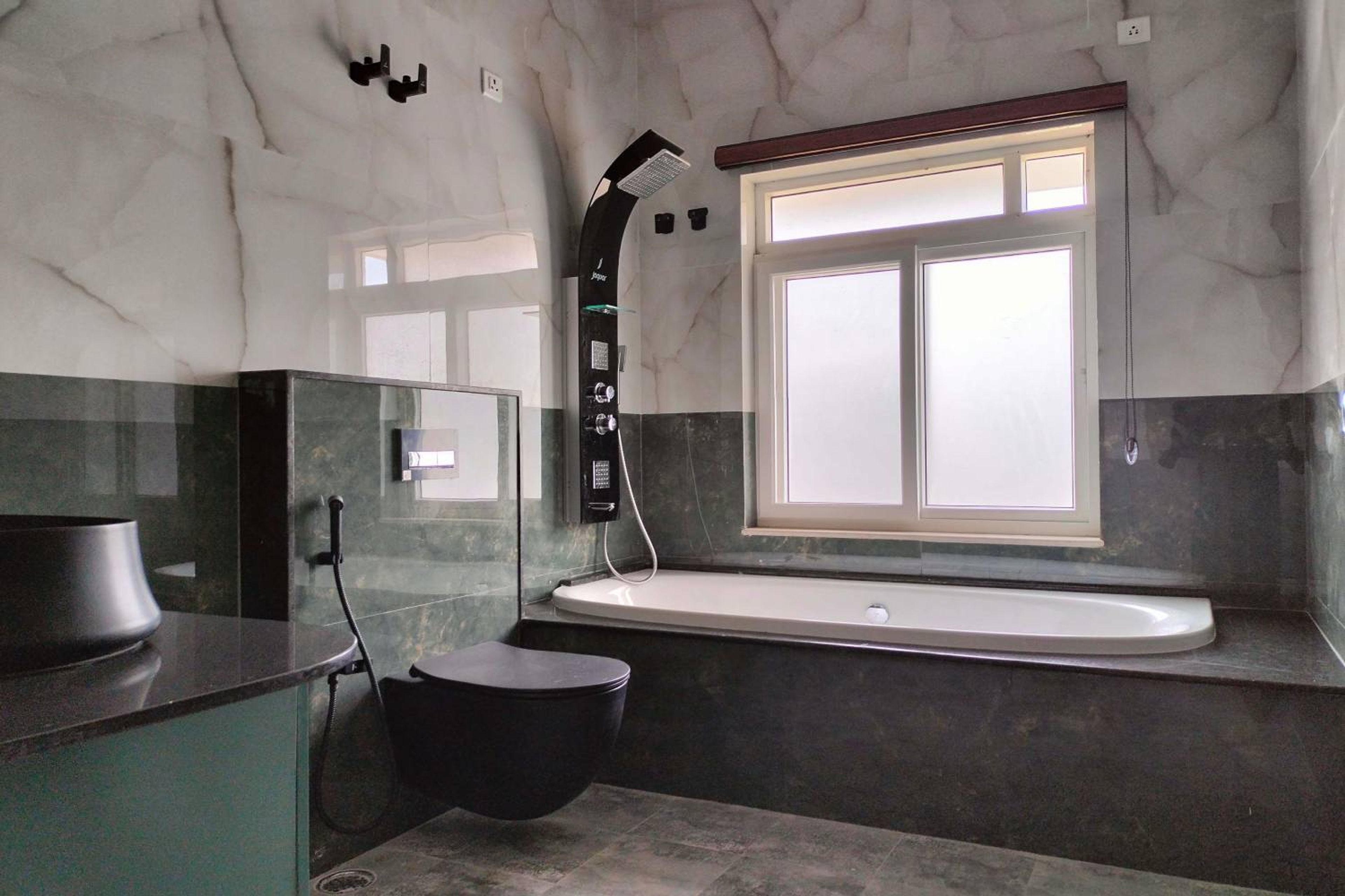 Modern Bathroom Design Featuring Marble Wall AndGreen and Cream Tiles