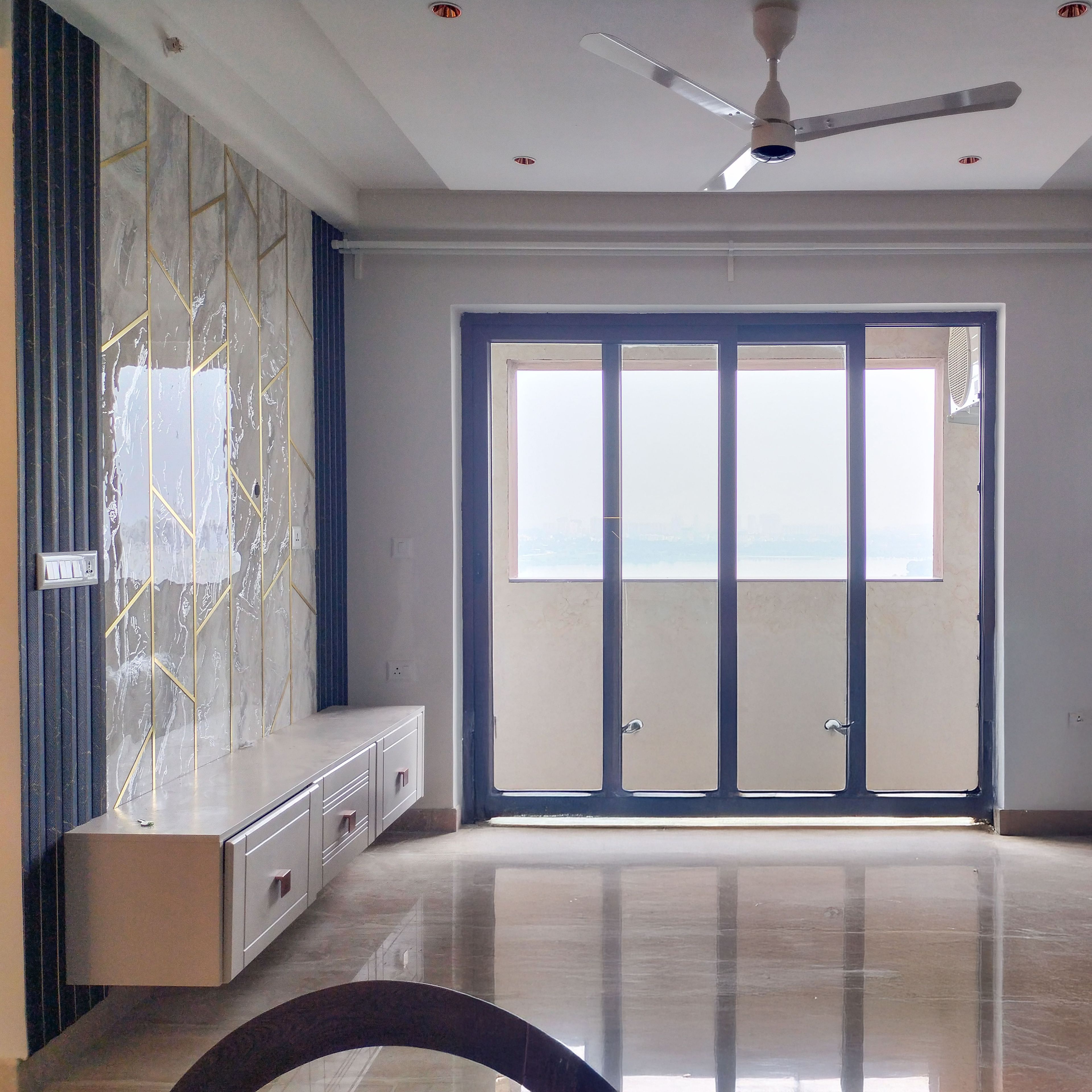 Living Room Design with TV Unit Design with Marble-Textured Tiles with Gold Inlays