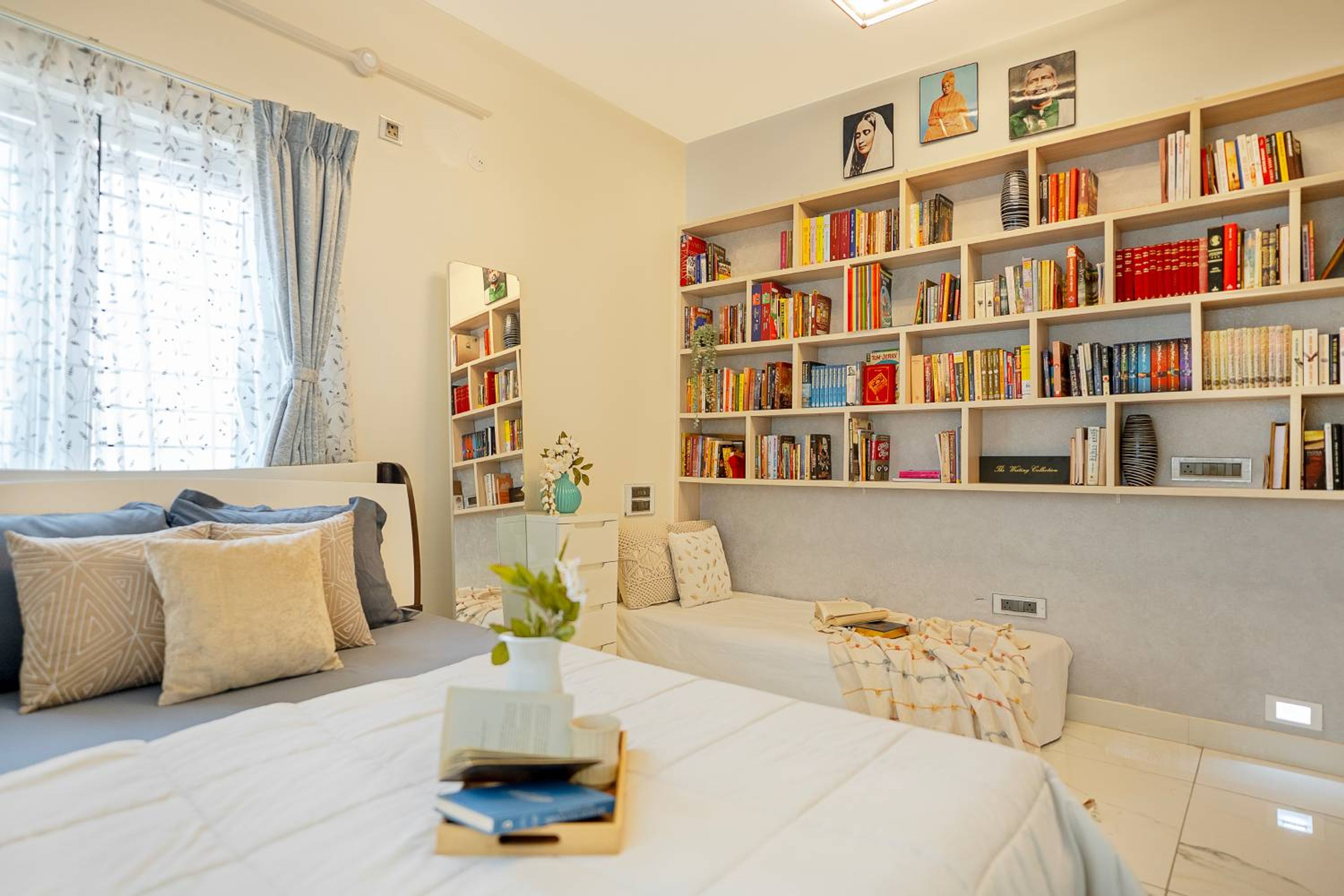 Master bedroom with light cream walls, gray curtains, white drawers, and full-length mirror