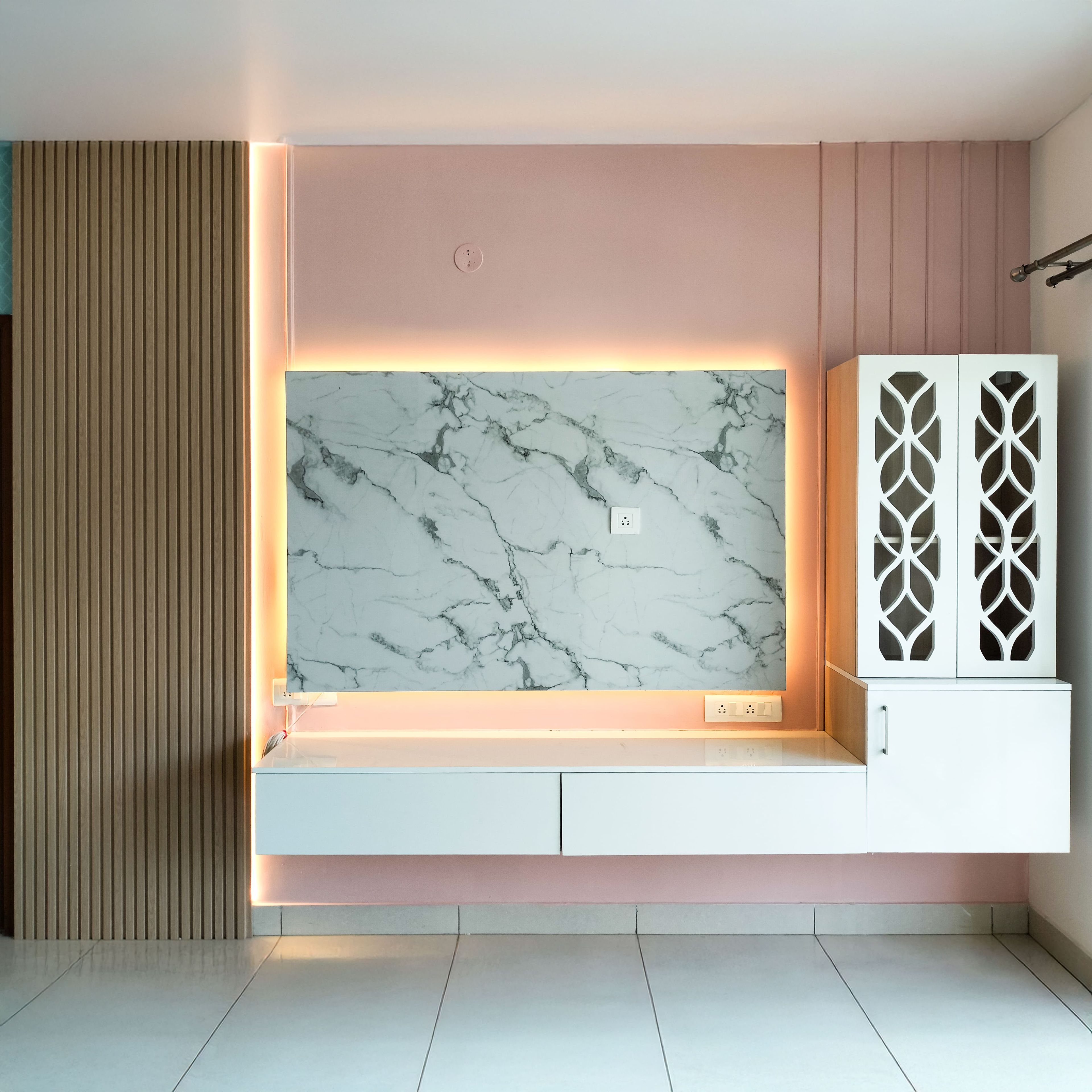 TV Unit Design with Marble Textured Backsplash and Closed Laaticework Door Pooja Unit
