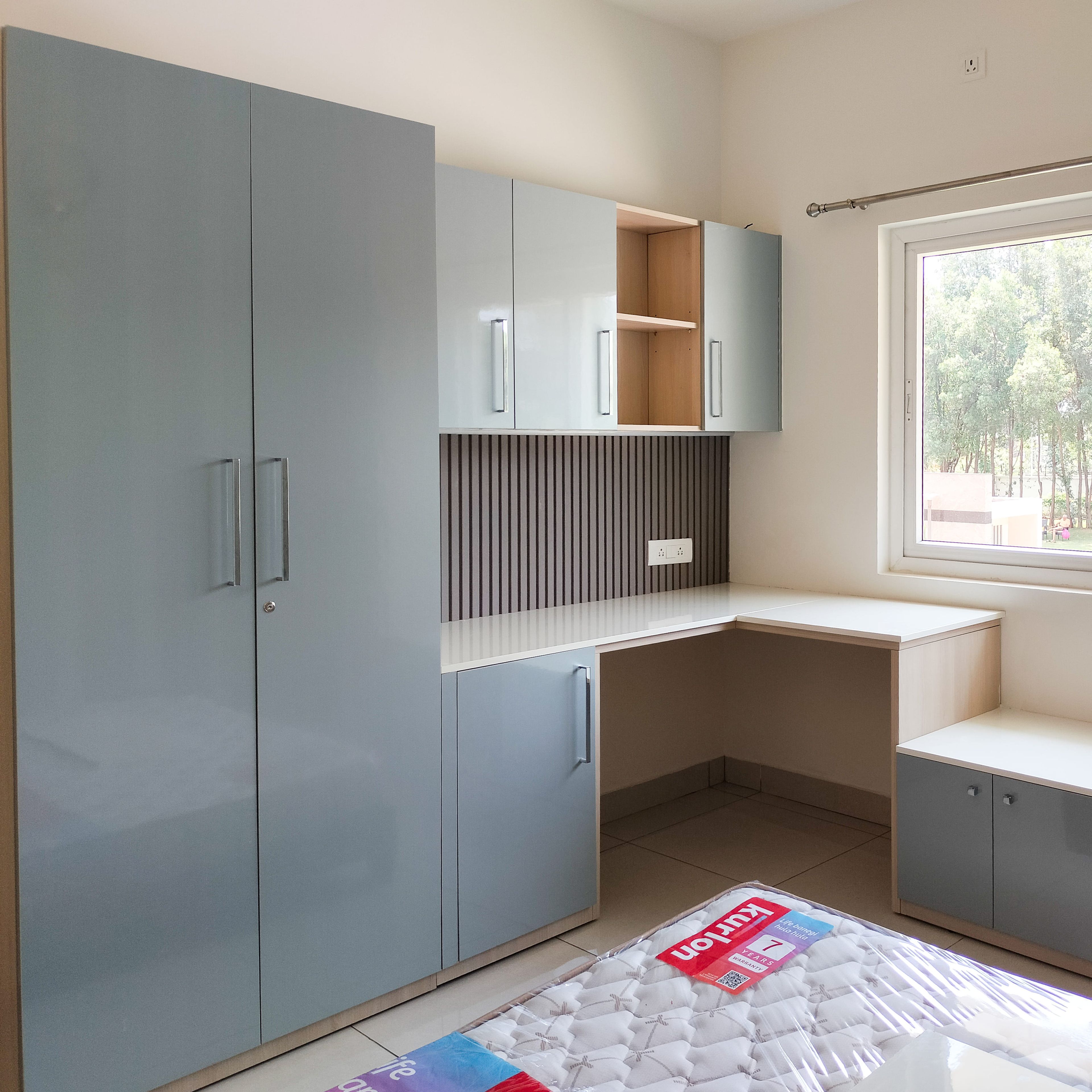 2-Door Powder Blue Swing Wardrobe Design with Attached White Study Desk and Blue Wall Cabinet