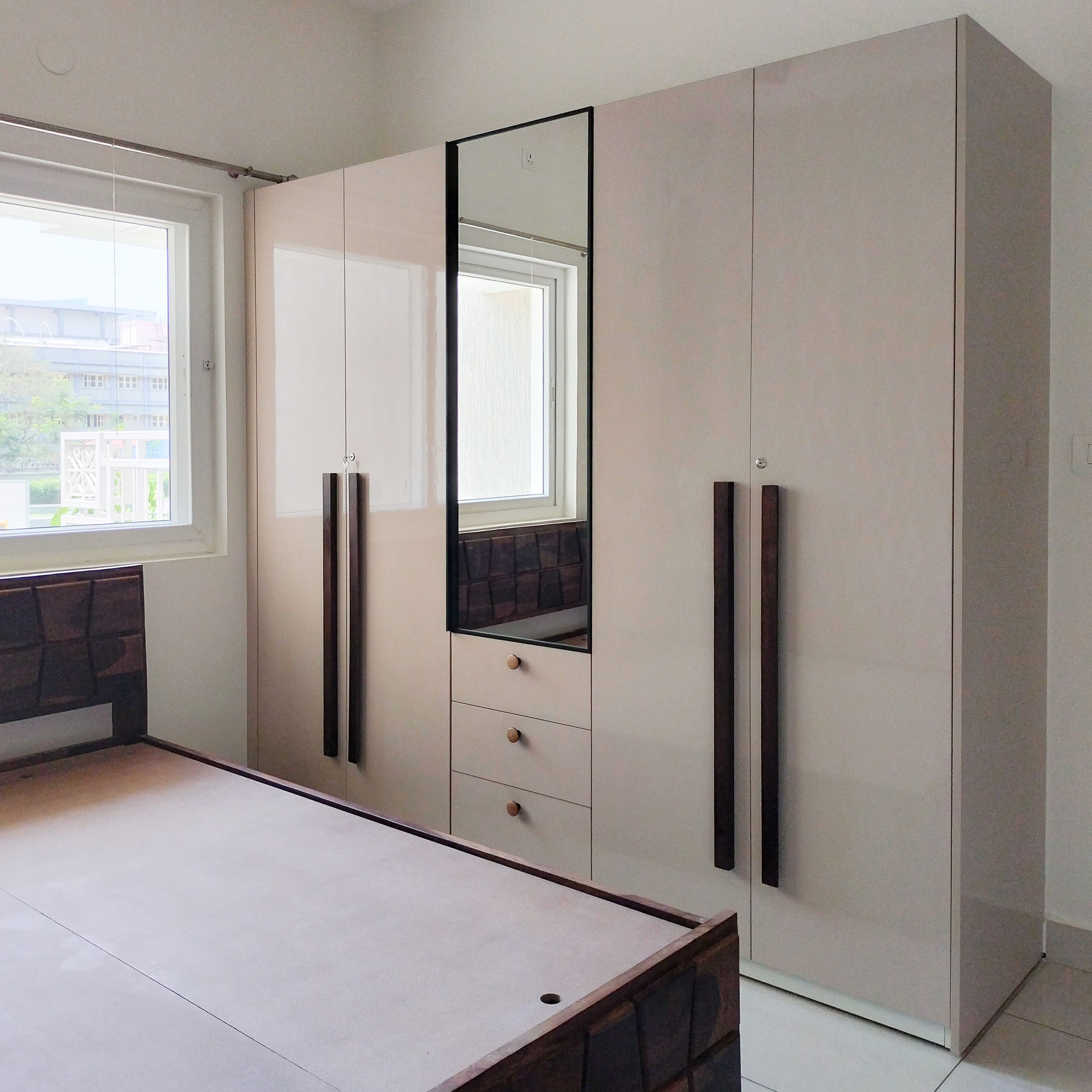 4-Door Beige Swing Wardrobe Design with Integrated Mirror and Drawers
